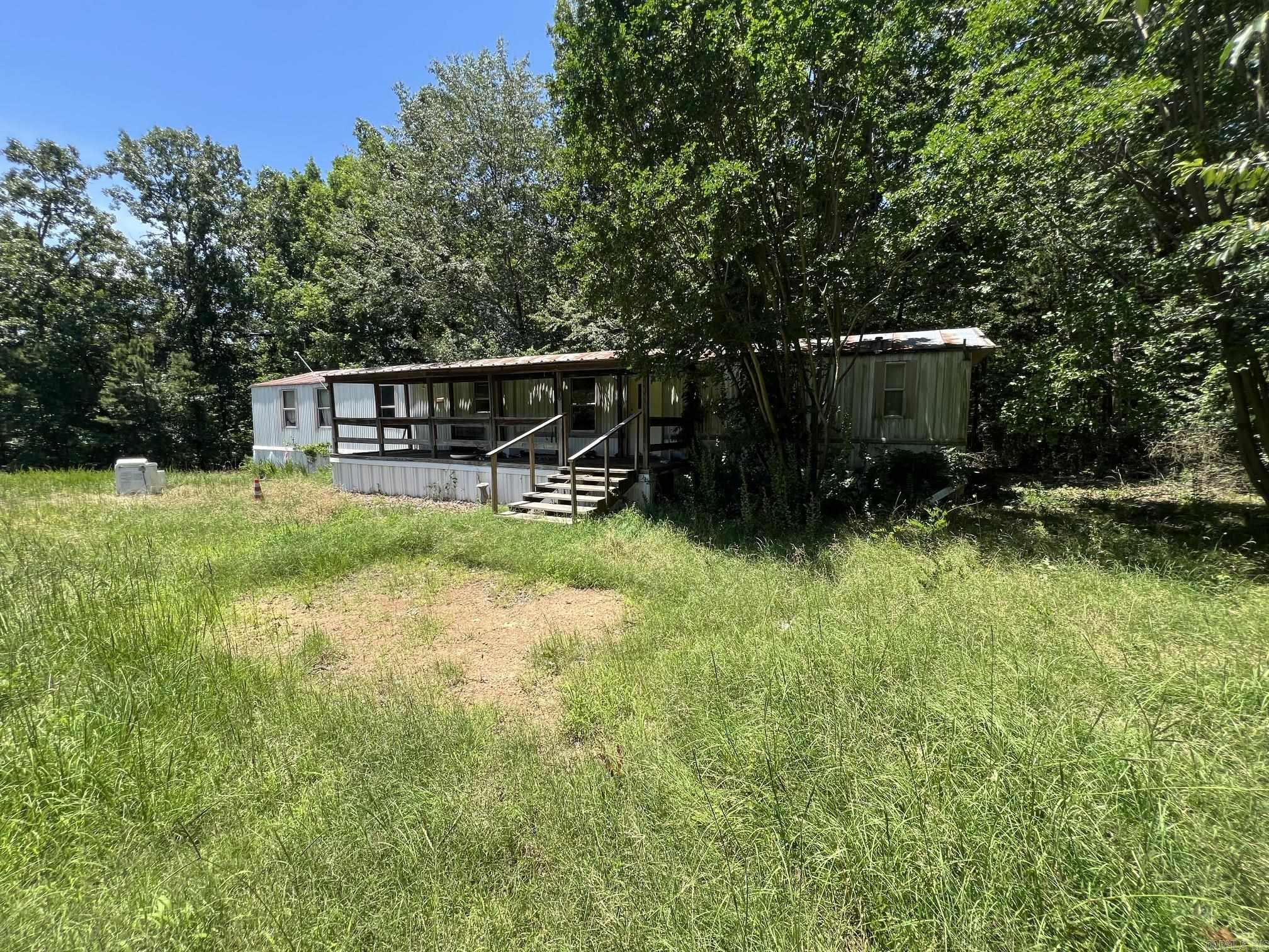 2.42 Acres with a 2002 model mobile home.  Land is being sold as is. Mobile home is in rough shape.  Close to Greers Ferry Lake.  Very Quiet Can't be seen from the road