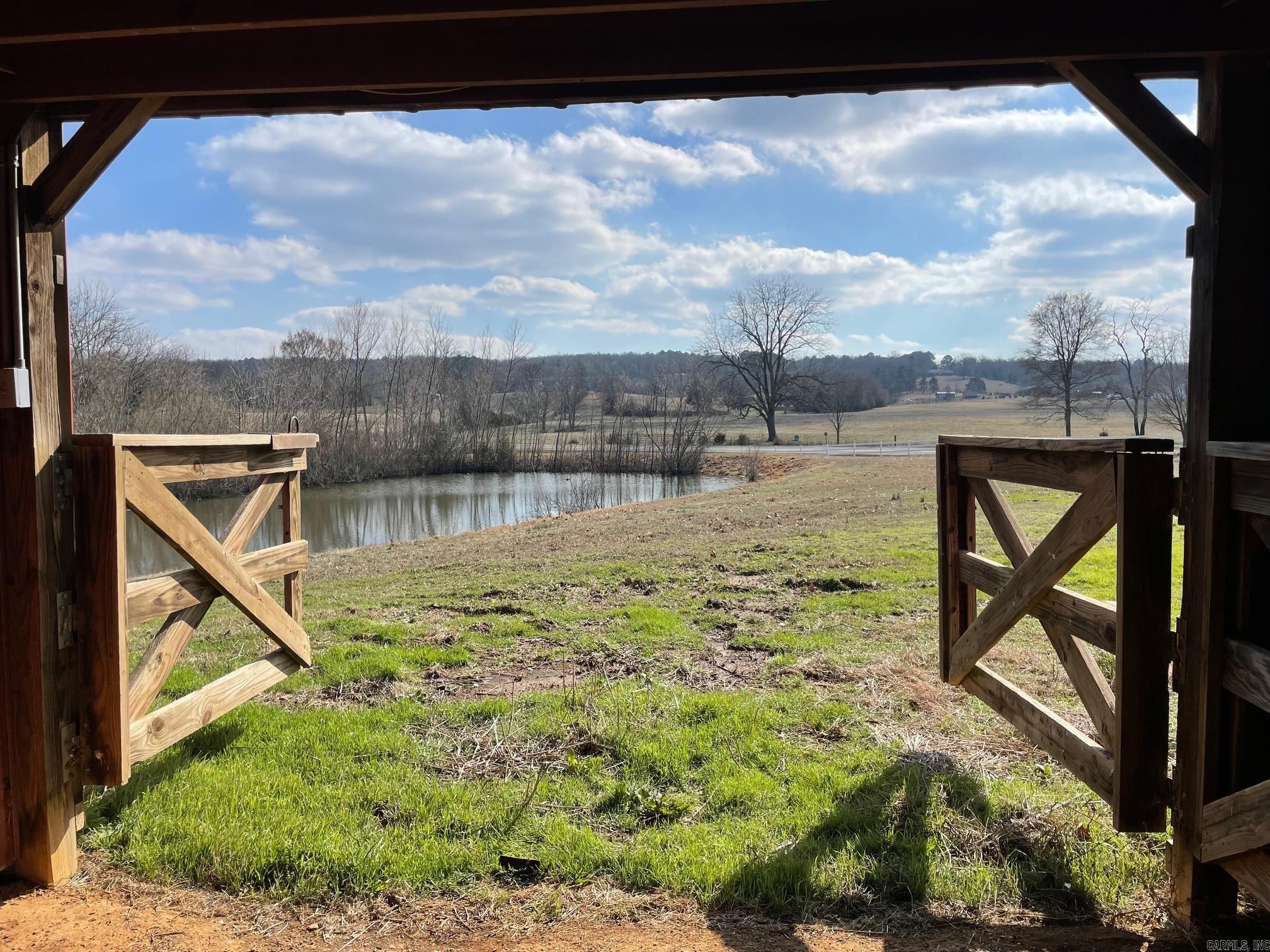Enjoy cleared pasture land with multiple amenities. 2 ponds, 2 barns and chicken coop. Well and storm shelter on site. Endless opportunities to do whatever you would like with this property. Multiple building sites make it perfect for your next home, development or farm with plenty of room to graze cattle. Close to the conveniences of town while still private. No mineral rights convey. No mobile homes.
