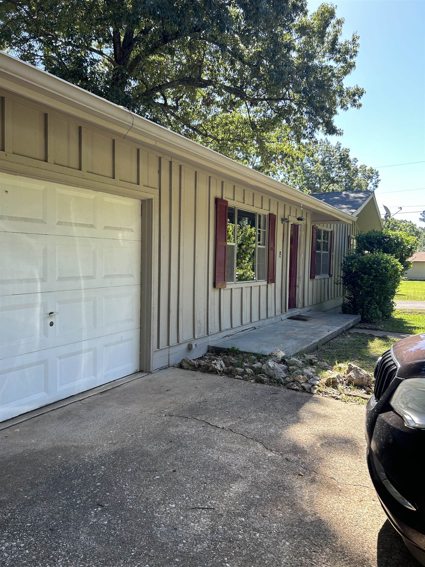 Avail Now...this 3 bedroom 1.5 bath home sets on a large corner lot with a fenced back yard. New appliances: side-by-side refrigerator & elec stove & vent hood. Home is all electric. The bathroom was remodeled with a nice walk-in shower. The garage could be converted into a 4th bedroom.  It has a window ac. Central HVAC. New Laminate flooring through-out. Washer/Dryer hookups. Also included is a large workshop with a 1/2 bath inside the fenced in back yard. Very versatile property. Can only be rented month to month due to future plans to list for sale so tenant will have the first opportunity to purchase. $25 will be added to the rent to cover pest control services. Each adult 18+ is required to complete an application.