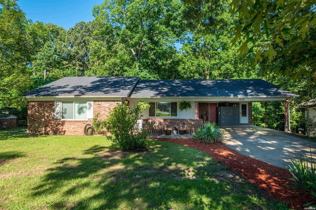 Welcome to this beautifully maintained 3-bedroom, 2.5-bathroom brick home. From the moment you arrive, the lush, manicured landscaping and classic brick exterior set the tone for the quality and care found throughout. Step inside and discover a warm, inviting layout designed for both everyday living and effortless entertaining. The bright and airy sunroom is a true standout — the perfect spot to enjoy your morning coffee, unwind with a book, or soak in the beauty of every season without ever stepping outside. The expansive backyard offers endless possibilities — whether you envision summer gatherings, a garden retreat, or a play area, the space is ready to make it happen. A 2-car carport provides convenient covered parking, while the surrounding neighborhood elevates the lifestyle even further. Enjoy peaceful strolls down tree-lined streets with the added charm of stunning lake homes directly across the street. This is the kind of home and community that’s hard to come by — don’t miss your opportunity to make it yours.