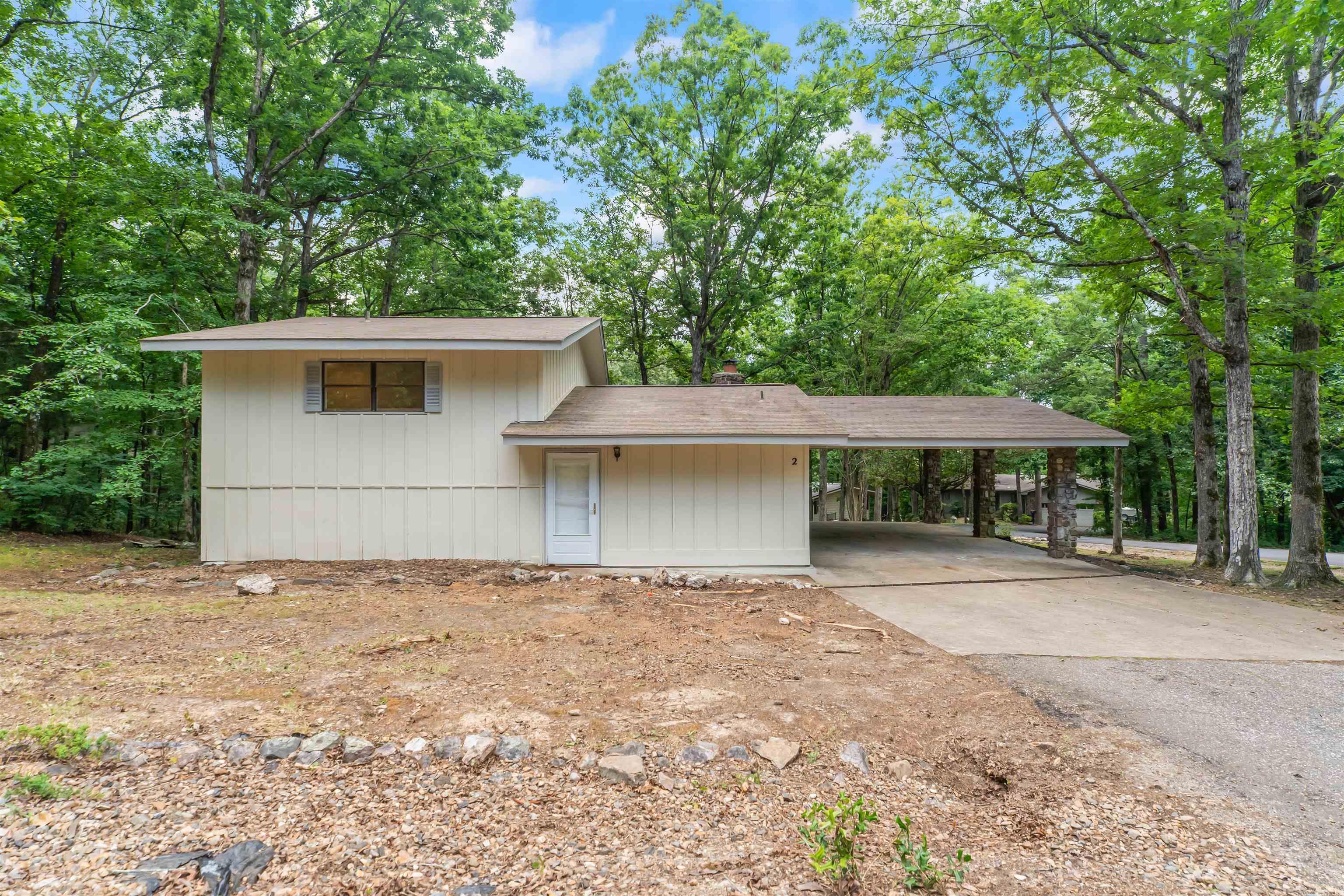 Turnkey and fully upgraded — 2 Hondo Lane has been transformed from top to bottom. New HVAC, new LVP flooring throughout, new stainless steel appliances, new quartz countertops, new vanities and tub, new interior and exterior paint, and a new hot water heater. Nothing has been overlooked.  The layout offers two separate living spaces plus a bonus room upstairs (possible office or workout space) opening onto a screened-in porch — and a massive two-car carport with sleek new sliding glass door access.  Step outside and you're minutes from Lake DeSoto, the pool and rec area, and Pickleball courts — plus less than 2 miles from Westgate. Seasonal lake views from the front round out this move-in ready gem in Hot Springs Village.