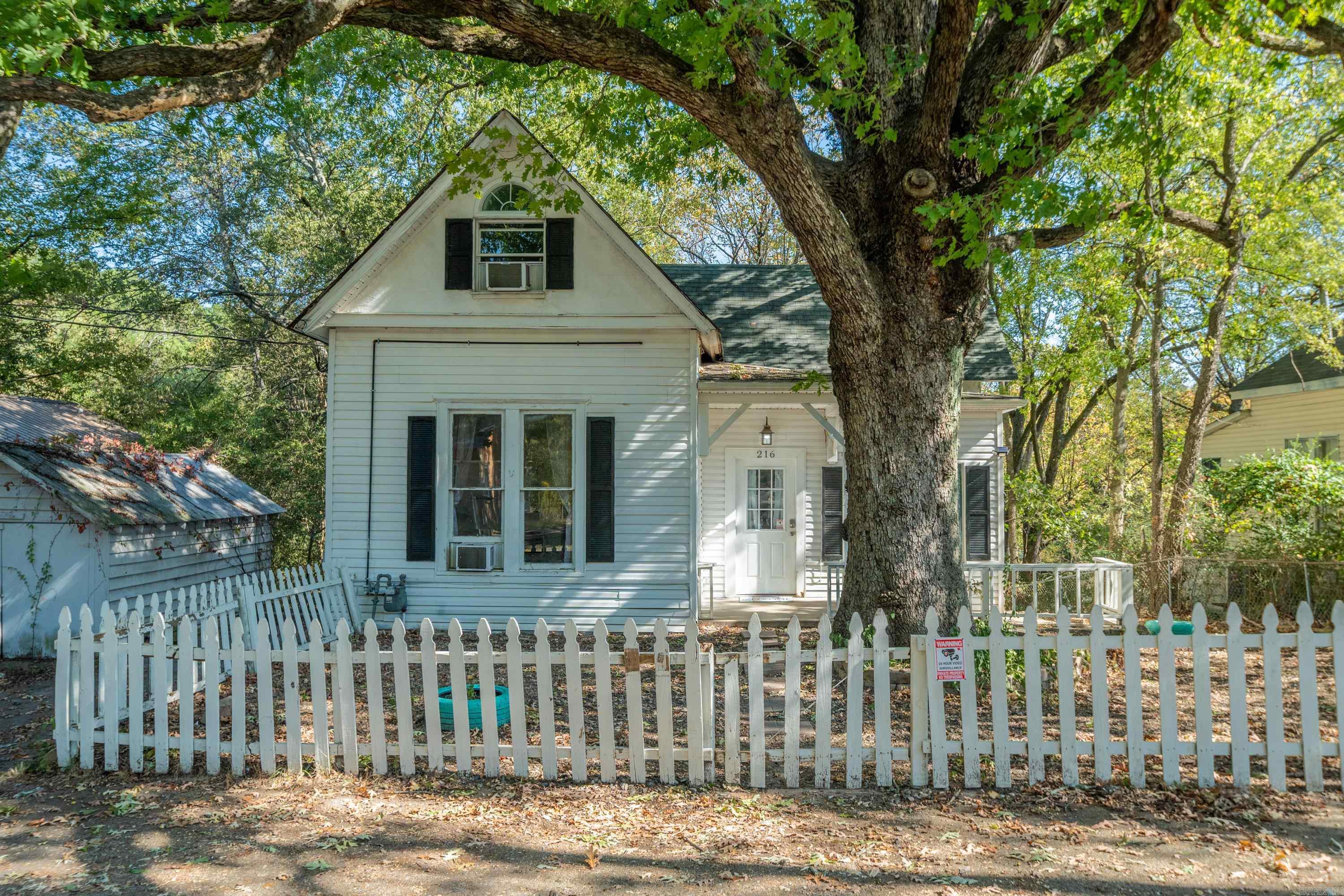 Welcome to this beautiful gem! Your opportunity is here to own a charming multi-level home full of character & history, boasting a stunning tree with branches that hold so many memories! Built in 1923, this 5-bedroom, 2-bathroom residence offers 1,700 sq ft of living space, an office, bonus room & is ideally located within minutes of the Historic Bathhouse Row. Step inside to discover classic architectural details including built-ins, ceiling fans, & a walk-in primary closet. The lower level has its own private entrance boasting 2 of the 5 bedrooms, a full bathroom, & a living room-making it ideal for a separate apartment or guest quarters. The finished basement with interior access to the crawlspace offers extra storage. Outside, enjoy a large backyard perfect for gatherings, complete with a deck & partially fenced-in area for added privacy. With three off-street parking pads, there’s plenty of room for you & your guests. This home is being sold as-is, offering a great chance for investors or homeowners to add their personal touch and build equity. Whether you're looking for a spacious family home or an income property, this one has the bones and location to make it truly special.