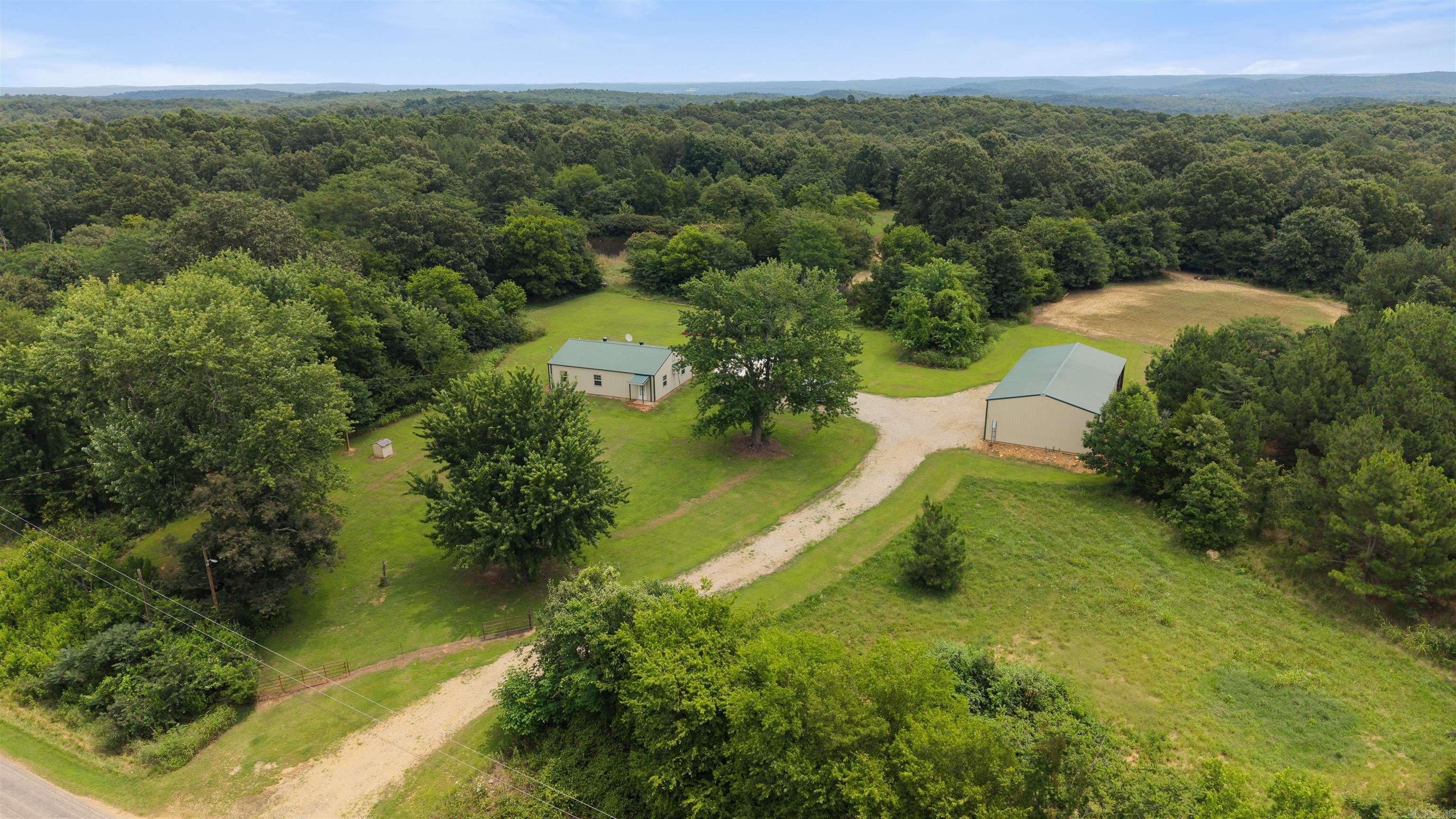 Properties like this don't come along often. If you've dreamed of owning your own private hunting retreat or peaceful country escape with no gravel roads, this 74± acre turnkey property is ready to make that dream a reality. From the moment you arrive, you'll appreciate the quiet, the privacy, and the feeling of having your own slice of the outdoors. The move-in ready cabin features beautiful wood ceilings, rustic charm, and an additional room perfect for an office, bunk room, or hobby space. It can even be purchased furnished—just bring your clothes and hunting gear. Approximately 2± acres of established food plots, two ponds, a MOTO deer stand, and automatic deer feeders create an exceptional setup for attracting wildlife. A John Deere tractor with implements and an insulated two-bay shop with a lean-to are included, making this truly turnkey. Whether you're chasing trophy bucks, creating family traditions, or looking for a place to unplug, this property offers a lifestyle that's hard to find and even harder to leave. Don't let this rare opportunity pass you by.