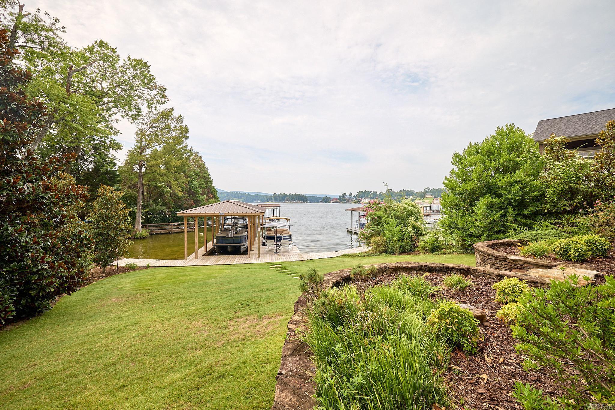 Lake living at its finest! Perfectly situated in Sunset Bay just off the main channel, the view from this updated FURNISHED lakehome is just beautiful! The main level boasts an open floor plan, high ceilings, chefs kitchen, primary suite, separate 2 bedrooms and 2 baths, and wonderful outdoor living and dining spaces. Downstairs there is another large living space with two more separate en-suite bedrooms and large porch. This 5br/5Ba lakehome has everything you would want (5th Bedroom currently used as den/study)! Convenient to all Hot Springs has to offer-Oaklawn, downtown, Garvan Gardens, shopping and restaurants. All new appliances, roof, tankless hot water heater too! No STR in this neighborhood.