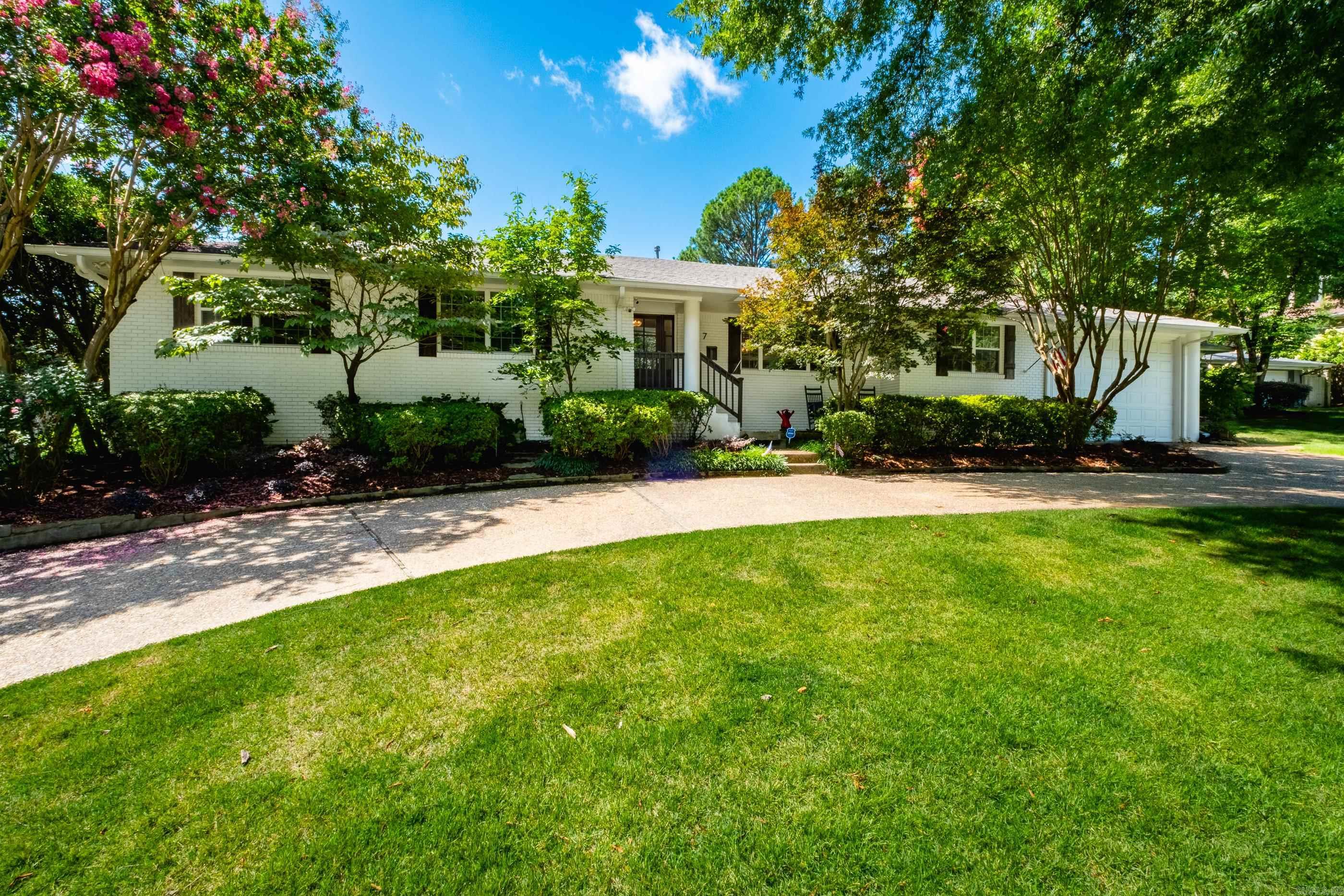 Recently featured in At Home Arkansas magazine, this spectacular, oasis-like family home is centrally located in the heart of Little Rock.  The one level floor plan offers open spaces for entertaining, a beautiful eat-in kitchen with marble counters and a large custom black walnut topped island, oversized living/dining area, wet bar with ice machine, beautiful hardwood floors, large bedrooms and closets, and a private primary suite with two walk-in closets and a beautiful en-suite bath. Also worth mentioning are the large laundry/ pantry, guest bath (complete with walk in shower), garage and new roof.  Last, but not least the backyard…AMAZING!  Gorgeously redesigned in 2022, the outdoor living space features a large pool, turf, magnificent landscaping, dining area, and a covered patio complete with wood burning fireplace.  It is a picture perfect place for year around outdoor relaxing and entertaining.
