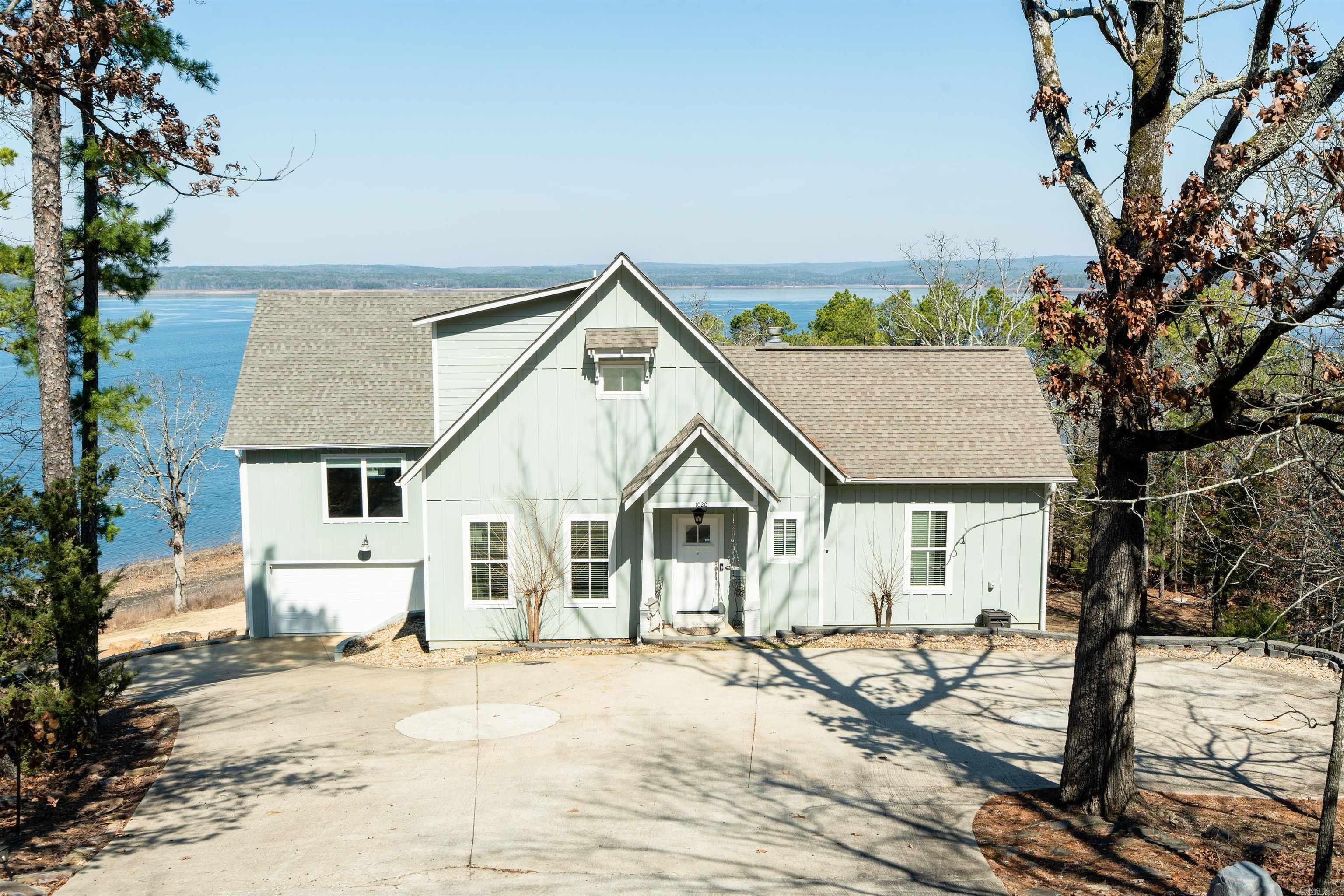 Eden Isle - LAKEFRONT HOME!  Located at the very northern end of Eden Isle, and built in 2017, this beautiful lakefront home has LOTS of living space!  Walls of glass overlooking Greers Ferry Lake from almost every room!  The newly added greatroom has very tall ceilings, glass on two sides of the room with corner fireplace, large deck with glass railings, kitchen with stainless appliances, island with breakfast bar, gas cooktop, coffee bar with sink and wine cooler, and half bath for main loving area.  The primary bedroom has a very large closet, beautiful lake views and private deck and lovely ensuite bath with walk-in shower, separate jet-tub and double vanity.  Covered outdoor dining, outdoor kitchen area, sunken hot tub on deck.  3-car garage is perfect for lots of lake toys!  Easy walk to the lake, small storm cellar.  Some of the prettiest views on the island!