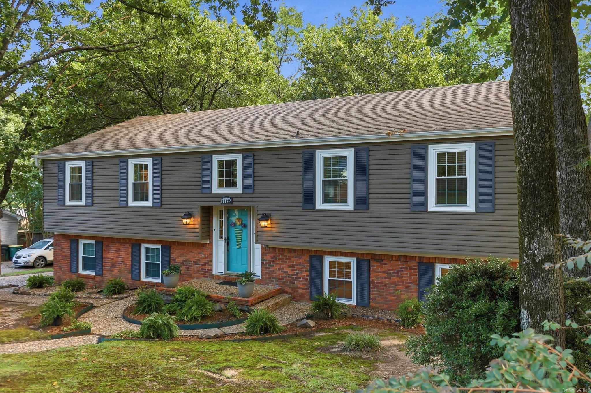 Tucked among mature trees in highly coveted Pleasant Valley, this spacious West Little Rock home offers flexible living, a beautiful backyard, and room to gather inside and out. This spacious 4-bedroom, 3-bath home offers a flexible floor plan with multiple living spaces and room for everyone. The main level features a generous living/dining room, a comfortable den/family room open to the kitchen, and great natural light throughout. The kitchen offers crisp white cabinetry, bar seating, stainless steel appliances, and an easy flow into the family room with a gas-log fireplace. Downstairs, a large additional living area with a full bath and soaking tub makes the perfect game room, media room, guest retreat, or even a private lower-level primary retreat. Outdoor living is a highlight with a large deck overlooking a beautiful, tree-filled fenced backyard. Walkable to the local elementary school and convenient to shopping, dining, and everything West Little Rock has to offer, this Pleasant Valley home blends space, location and lifestyle.