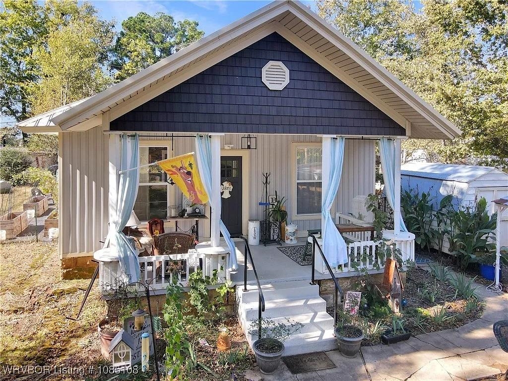 Perfectly centered in the walkable heart of historic Hartford, Arkansas—just steps from the post office and city hall. Built with early 20th-century bones and reborn with thoughtful custom design, this single-level retreat radiates authentic farmhouse vibes while delivering move-in-ready comfort. Step inside to warm flooring, and a split-bedroom layout that maximizes privacy. The open living area flows seamlessly into a bright kitchen featuring a gas range, and ample storage—ideal for Sunday suppers or canning from your own garden harvest. Both bathrooms shine with modern fixtures, while built-in shelving, a dedicated mudroom, and ceiling fans throughout add everyday ease. Outside, the magic multiplies. Unwind on the relaxing covered front porch—your new favorite spot for morning coffee or evening chats, complete with space for rocking chairs and fluttering curtains to frame the small-town views. The fully fenced backyard is an entertainer’s dream, plus a handy storage building for tools, bikes, or holiday décor. Multiple garden areas hug the perimeter—raised beds already prepped for vegetables, herbs, and flowers—inviting you to dig in and grow your own homestead bounty.