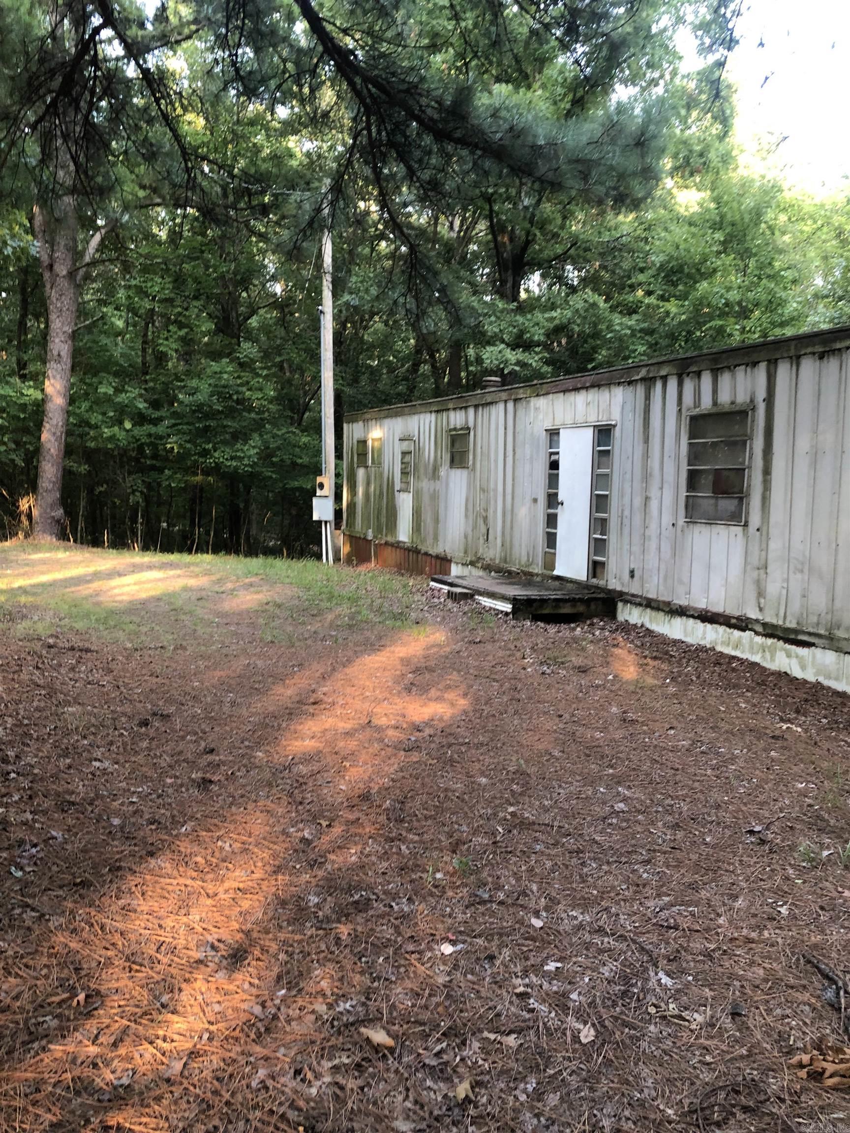 If your wanting OUTSIDE OF TOWN look at this lot for a potential purchase.  While the mobile home does have potential for the right buyer you may want to put a new home on this lot. Lot is being sold AS-IS