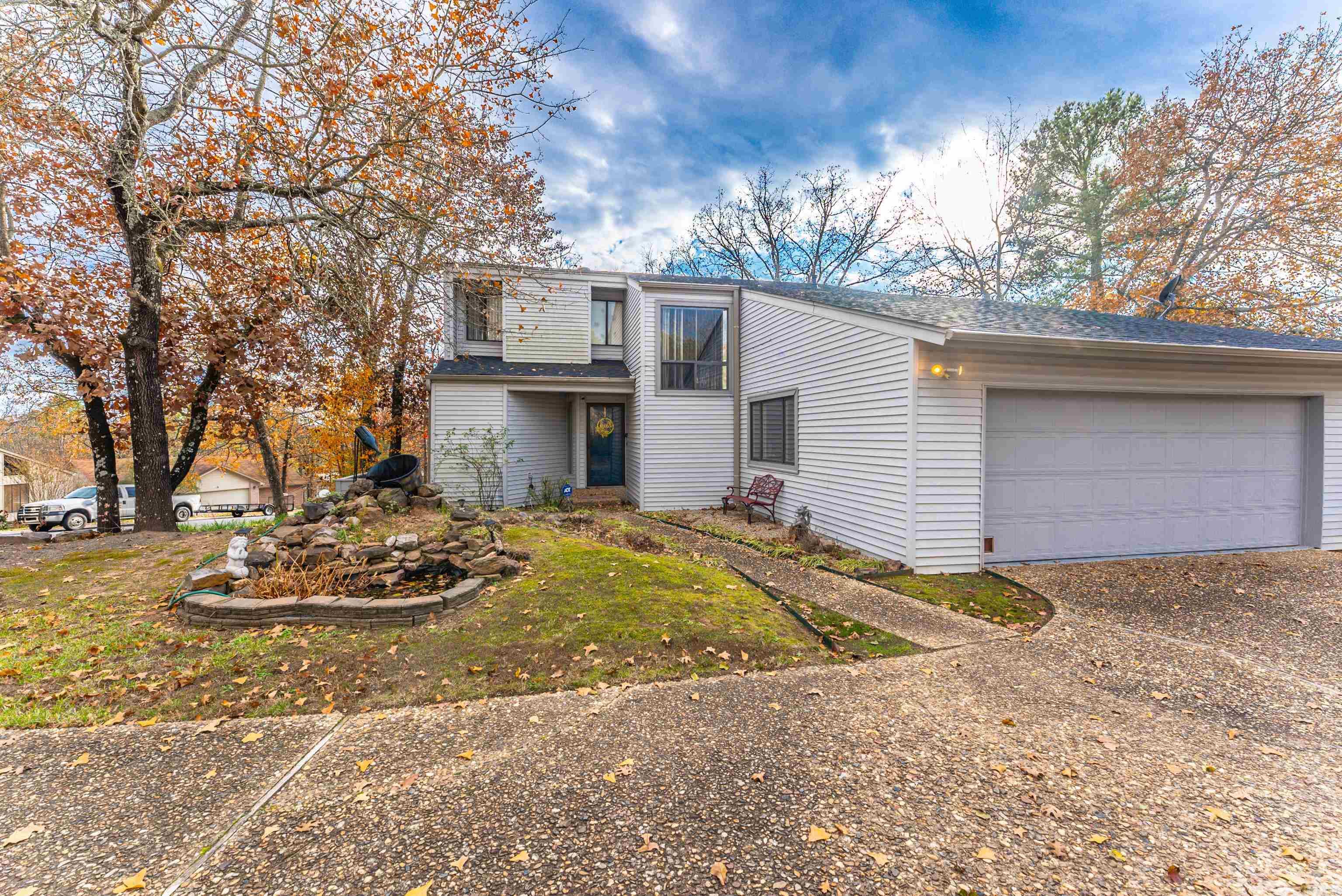 Discover this charming contemporary-style home situated on a spacious lot, filled with natural light from its large windows and an inviting open layout. The kitchen features granite countertops and a custom wood barn door to the walk-in pantry, while the main-level primary suite provides a comfortable retreat. Upstairs, you’ll find two bedrooms, a full bath, and a versatile bonus room or potential fourth bedroom. The oversized garage includes a convenient full bath, and the outdoor space boasts a large deck, serene landscaping, and an in-ground firepit—perfect for relaxing or entertaining. With nearby walking trails to two lakes and updates like a 2020 roof and water heater, this home offers a unique blend of charm and functionality.