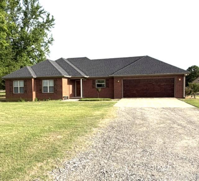 Seeking a rural residence situated on over 10 acres of land, complete with a stocked pond?  Look no further!  This beautiful, well-maintained brick 3/2 decorated home, featuring a spacious back porch is ideal for hosting gatherings. The inside stained concrete floors and fireplace is aesthetically pleasing.  The expansive acreage is fenced and cross-fenced, supporting multiple outbuildings.  The large concrete-floored barn equipped with a 1/2 bath, is perfect as a working barn or mechanic shop. Additionally, the property includes a tack barn with 2 horse stalls and additional space for a separate business The building with the double carport has a tool/garden shed and additional sq ft for a possible She Shed., A metal shed located at the rear of the property would be suitable for raising chickens. The property also has an inground storm shelter that will easily support 12 people?  Call today for a showing?  Agents see remarks.