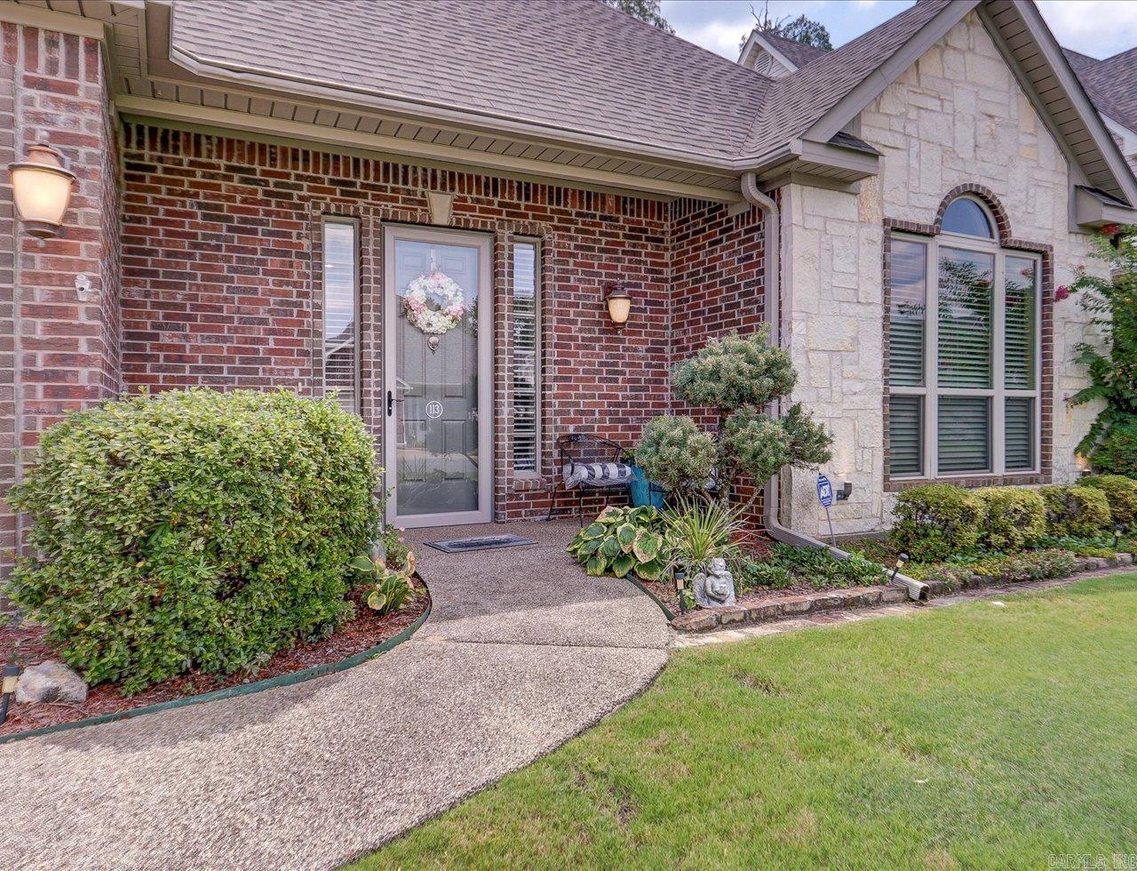 Elegant, Energy-Efficient Home with Bonus Space & Lake Access! Step inside this immaculate 4-bedroom, 3-bath home in the sought-after Burchwood Cove community, just steps from Lake Hamilton. With over 3,000 sq. ft. of thoughtfully designed living space, soaring 10’ ceilings, and an open floor plan, this home blends comfort, style, and energy efficiency. The spacious primary suite features a walk-in closet, dual vanities, and a spa-inspired bath. A guest bedroom and full bath on the main level offer comfort and convenience for family or visitors. Hardwood floors, crown molding, and a gas-log fireplace with remote control create warmth and elegance. The gourmet kitchen includes a breakfast bar, stainless appliances, gas range, abundant cabinetry, and both a separate dining area and casual breakfast nook. Upstairs, you’ll find a large bedroom, a full bath, and a versatile bonus/flex room— perfect for a home office, media room, or 4th bedroom. New roof (2023) Low-E insulated windows & extra insulation for year-round efficiency, HOA-maintained front lawn and sprinkler system, access to neighborhood security camera system, private subdivision boat launch for Lake Hamilton. Call today!