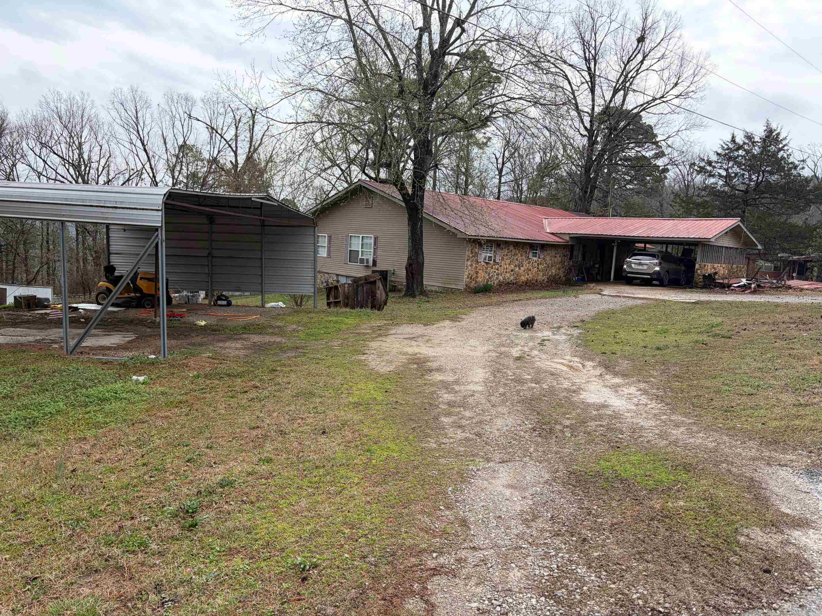 Great Location!  Convenient to Norfolk Lake, White River and Norfolk Rivers.  Lots of square footage in this Stone home with mostly metal roof, attached carport and basement storm shelter.  Kitchen with island, vaulted primary bedroom, third bedroom has a den attached.  Primary bathroom with dual sinks! Two gas Fireplaces and a wood pellet stove!  Gas heaters/electric heat pump for cooling.  Back yard is fenced. Some areas of siding aren't completed, carpets need to be replaced, some rooms with lower ceilings. Other Cosmetics and general fixing up needed, but for the right buyer, it could be made into something special.