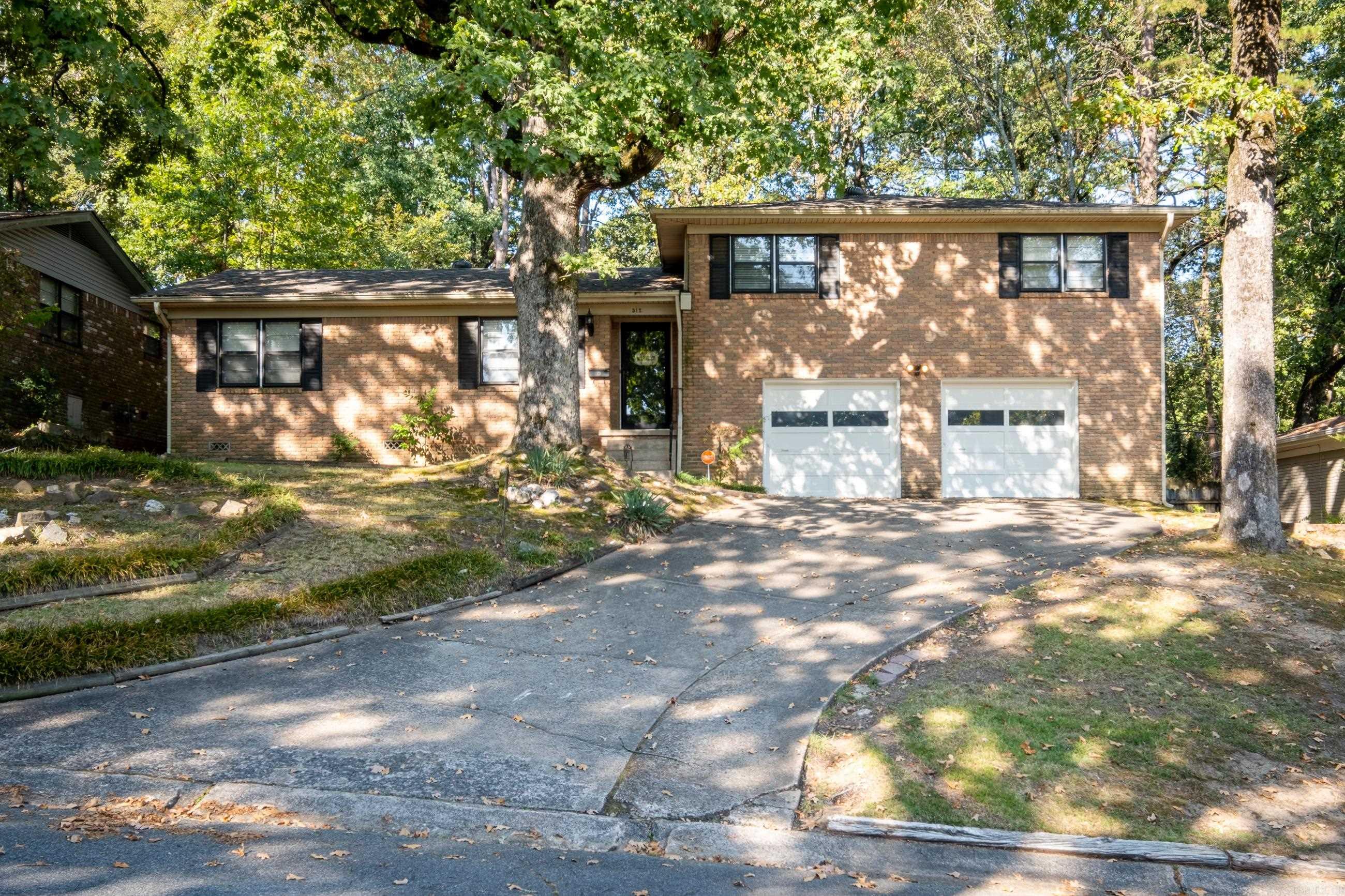 Popular mid-town location. New roof 2023. HVAC replaced 2016. Updated kitchen w/granite & updated primary bath. No carpet-Beautiful hardwoods & tile. Move-in condition. Entertaining-size living area w/built-ins. Updated kitchen w/granite, under counter lighting & breakfast bar. Spacious dining area w/new lighting. Abundance of cabinets, pantry & storage in kitchen. Few steps up to 3 BR & 2 full baths. Primary bath updated w/ spacious walk-in shower, marble vanity & marble tile floor. Updated lighting in dining area & both full baths. Recessed lighting in living, kitchen & dining area. Bonus room downstairs featuring built-ins & closet plus half bath - could be 4th BR. 2 car garage. Fenced backyard & patio.