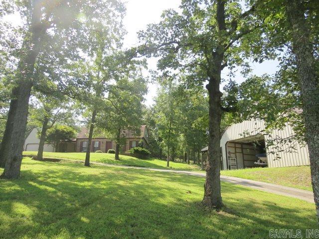 QUIET AND WOODED.  Recently remodeled and plenty of room for your growing family.  4 BR, 3 BA home plus formal living room, dining room, family room and finished loft.  Large laundry room, extra closet space and built-ins.  30' x 40' insulated pole barn, circle drive and fenced area in back yard.  Two water heaters, one for each floor. Additional acreage available.