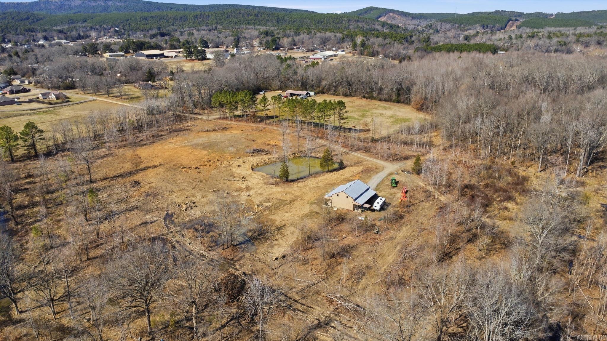 Welcome to an Outdoorsman's Dream Property! This beautiful property consists of a 30x50 Barndominium with an Enclosed Garage and easy-to-access Upstairs (Unfinished), 183.14 Acres of proven Hunting Land, established and cleared Shooting Lanes, Riverfront Access, 3 Ponds, and an established House Pad to build your Dream Home. The Barndominium offers a Studio-Style Living Space, finished Bathroom with Walk-in Shower, Spacious Kitchen with Kitchen Island. Easy to maintain Concrete Flooring throughout (LVP in Kitchen Space). The Barndominium is complete with 10 Ft. Covered Porch Awnings, offering breathtaking views of the Property. Peaceful and Quiet, 1003 Wildwood Cove is the ultimate Oasis and is awaiting its New Owner.
