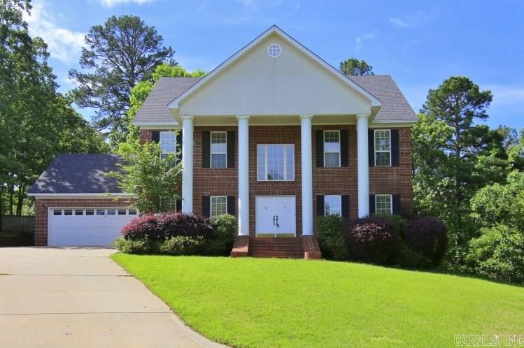 Charming Southern Colonial beauty on 1/2 acre lot w/trees & green space on 2 sides. Beautiful pecan hardwood floors shine in this light filled spacious home with 2 story entry. Formal DR, living room w/French doors to large hearth room w/WBFP & gas logs, kitchen w/slab granite, SS appliances & breakfast bar, hall 1/2 BA & laundry down. Up are 3 nice guest BDRMS (one w/deck)& 2 guest BA (1 is J&J). Oversize vaulted Master Suite with his & her closets, Jacuzzi tub & large shower. Deck, 2 car garage. Come See!