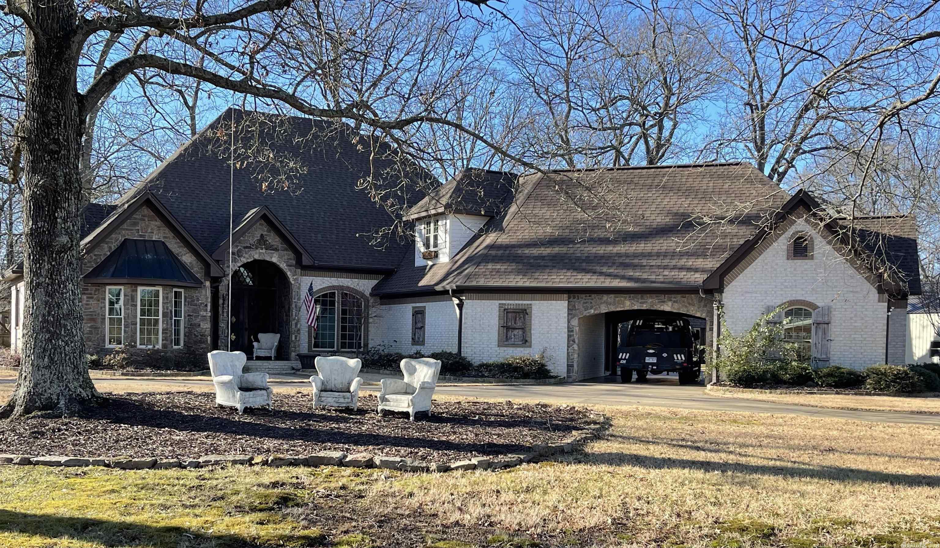 Beautiful secluded home on 40 acres! If you are looking for privacy with electronic gate entry and property fenced..you have found your dream home. 4 BR and 3.5 bath. Office, Dining Room, Den, Sunroom,  Master and 2 additional BR's on main level and one MIL quarters upstairs. 2 separate garages with pull through portico. Safe room. Swimming Pool with guest house. Outside entertaining area. 30x30 shop. Entertaining barn with fireplace, fridge and is heated and cooled. This property has it all! See remarks!