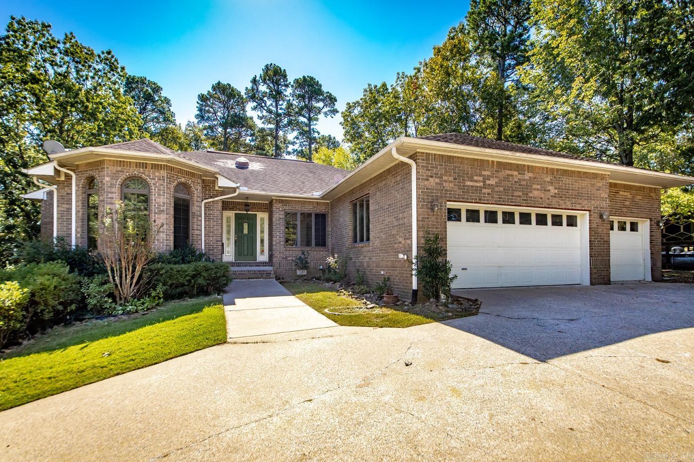 Motivated Seller!! Golf-front brick beauty on a shaded double lot in Indian Hills. Tucked along the 10th green, this home delivers a true golf-course lifestyle with rare extra space, privacy, & timeless curb appeal. Set on a generous, tree-canopied double lot, the property offers cool afternoon shade, a quiet natural buffer, and plenty of room for outdoor living—garden, games, grilling, or future enhancements. Unwind on the screened-in porch with serene, year-round views of the green.  Inside, fresh luxury vinyl plank flooring runs throughout for a clean, cohesive look. The large kitchen provides ample prep space and storage, ideal for daily living or entertaining. A comfortable primary suite creates a private retreat, and the oversized 3-car garage handles vehicles and gear with ease. You will love the extra garage workshop, its perfect for a golf cart or ATV/UTV.  Fairfield Bay has so many outdoor activities to enjoy such as pickle ball, tennis, hiking, 80 miles of atv/utv trails, 2 golf courses and one of the cleanest lakes in the United States.  Enjoy effortless living where golf, lake days, dining, and recreation are just moments from your door. Schedule your showing today.