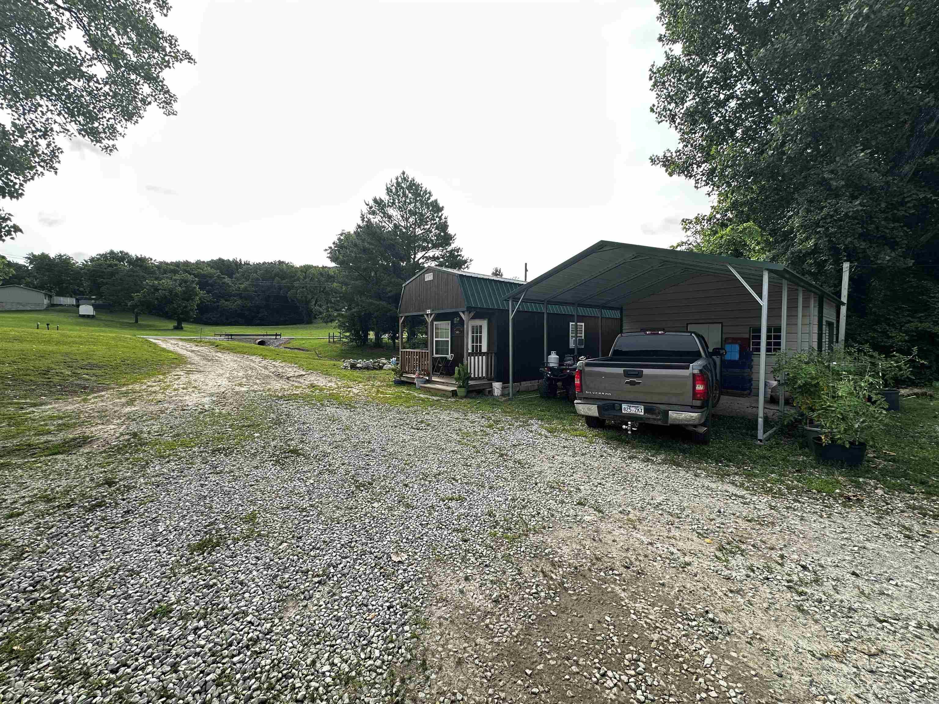 Discover the possibilities with this charming 1-bedroom, 1-bath tiny home situated on 0.84 acres m/l in the heart of Guion, Arkansas. Whether you're looking for a vacation getaway, an income-producing nightly rental, or a low-maintenance full-time residence, this property offers flexibility to fit your lifestyle. Located just seconds from the renowned White River, outdoor enthusiasts will appreciate quick access to some of the area's best trout fishing, floating, kayaking, and recreation opportunities. The thoughtfully designed home makes efficient use of space while providing comfort and functionality. A spacious two-car carport offers covered parking and convenience, while an attached storage area with a garage door provides the perfect place to store a mower, ATV, fishing gear, tools, or other equipment. The generous lot offers room for outdoor entertaining, future improvements, additional parking, or simply enjoying the surrounding Ozark scenery. Conveniently positioned in Guion, you'll enjoy easy access to everything that makes this river community a sought-after destination for visitors and residents alike.