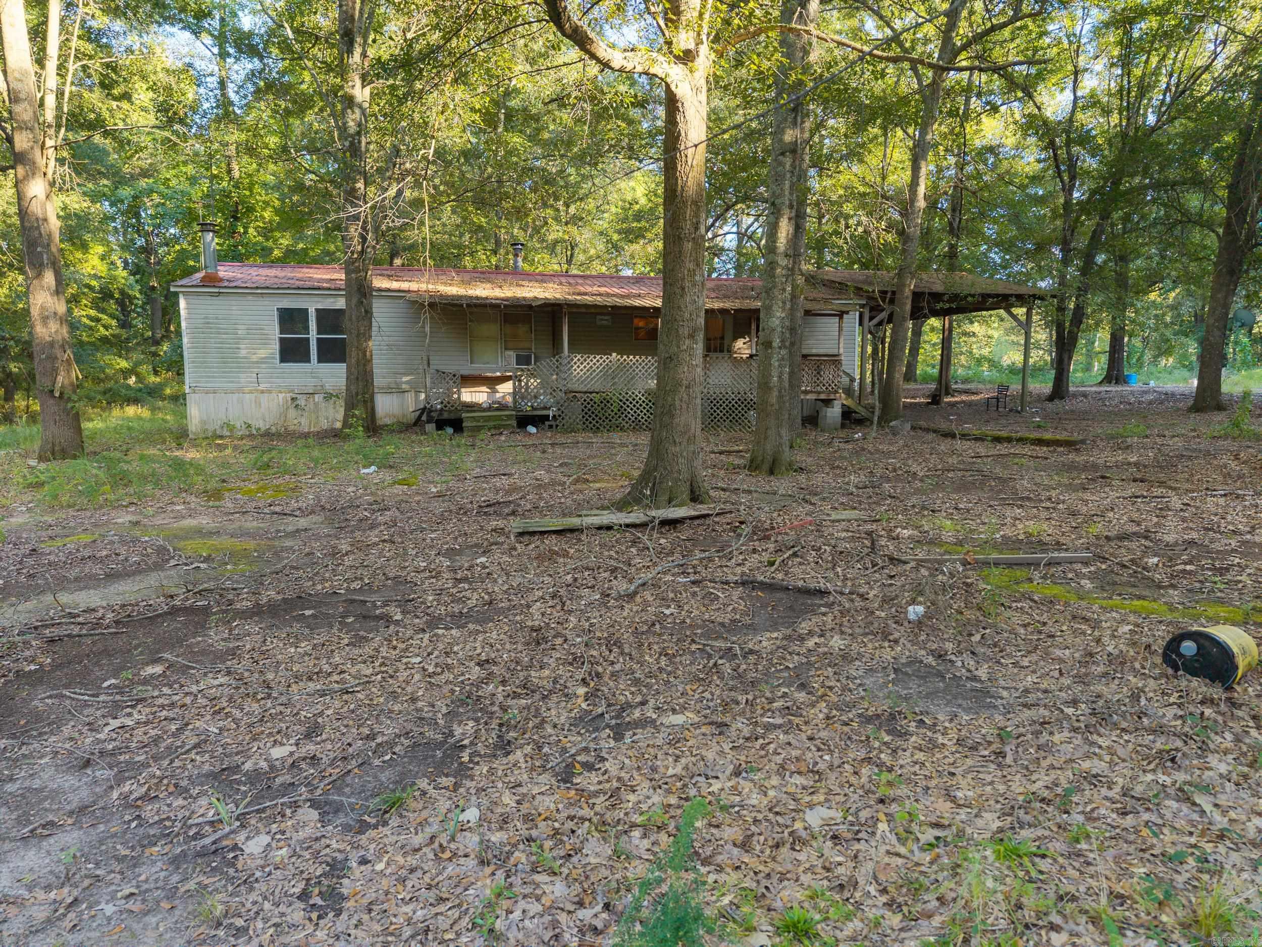 Welcome to 401 S Fourth Street in Georgetown, AR! This property sits on approximately 7.5 acres of unrestricted land and features a spacious double-wide manufactured home with 3 bedrooms and 2 bathrooms plus bonus room, complete with a durable metal roof. A shop provides extra storage or workspace, making this a versatile property for a variety of uses. Located near some of the best duck hunting in Arkansas, this could be the perfect setup for an outdoorsman’s retreat, duck camp, or full-time residence. With plenty of room to spread out and no restrictions, the possibilities are endless—bring your hobbies, hunting gear, or investment ideas and make this unique property your own! Agents see remarks.