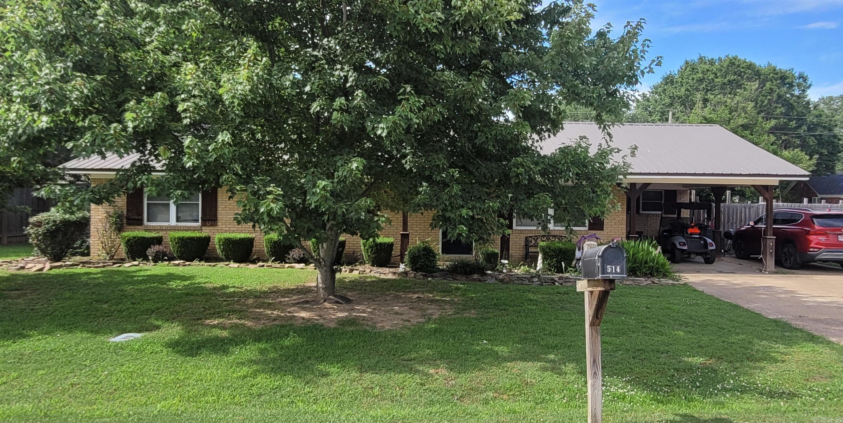 Get in to see this one quickly! Super cute three bedroom, two full bath brick home with a metal roof, patio, shop, storm cellar, and privacy fenced back yard has extra landscaping for great curb appeal and is located on a corner lot in a desirable neighborhood in McCrory School District.