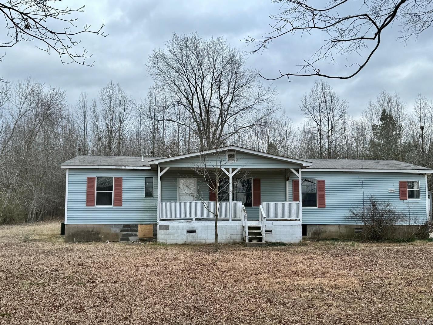 This mobile home has a remodeled interior and sits on 1 acre in the country.  Located 1/2 mile from Bald Knob Refuge, the home is close to wonderful public hunting land.  The interior has fresh new paint,new kitchen countertops; new hot water heater; new flooring, beautiful vanities in bathrooms and a wood burning fireplace. A large back deck overlooking a large back yard wih a large storage shed. 3/2 wth a large living area, central heat and air, fire place and laundry room.  agents see remarks