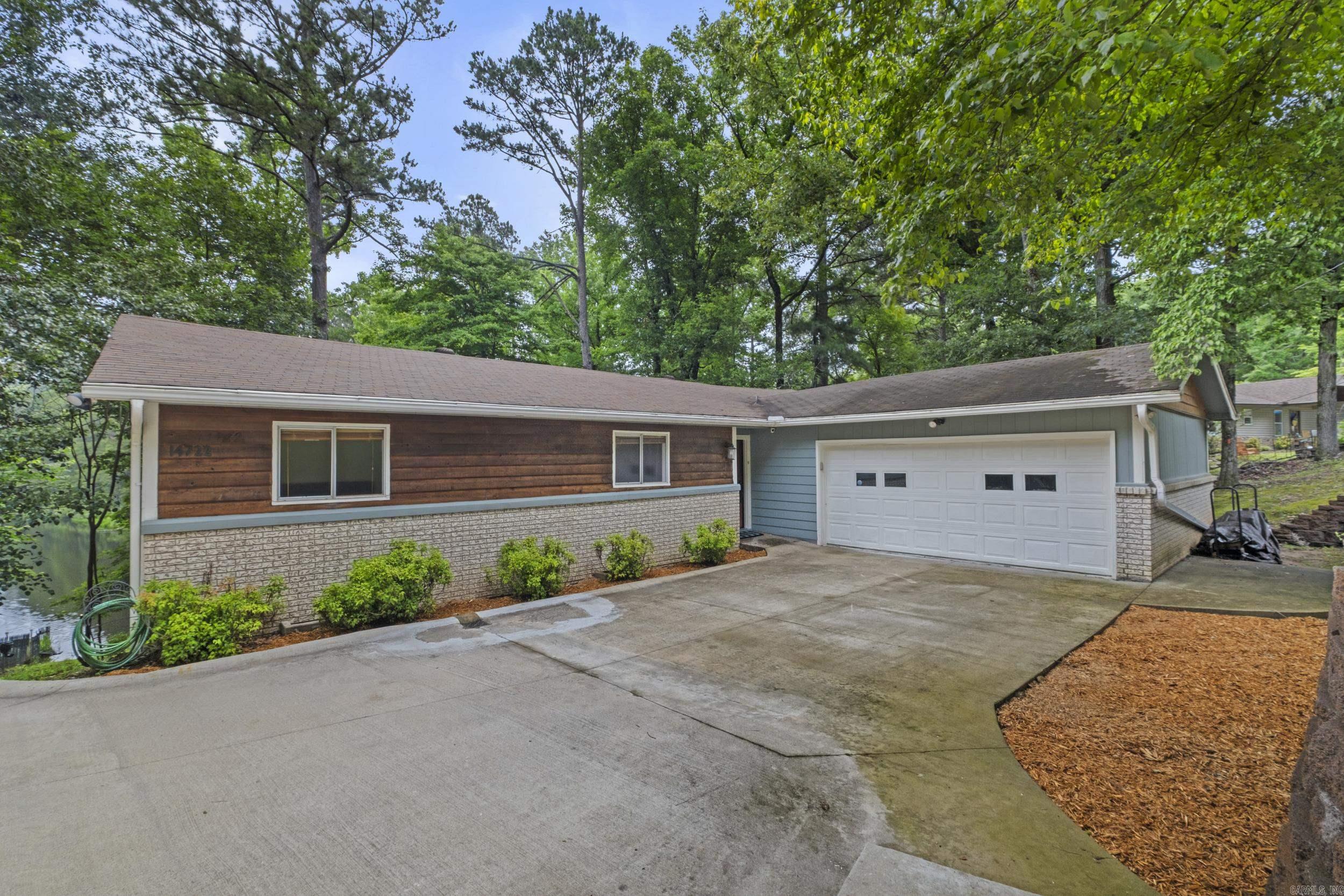 LAKEFRONT RETREAT in beautiful Spring Valley Manor neighborhood!  Enjoy the privacy of the secluded lake #3, while still taking advantage of Lake #2's recreational fun of swimming, boating, canoeing and many neighborhood events. This house has so much to love!  Sit on your back deck to enjoy the expansive views.  The combined living area/kitchen/dining area also take advantage of the scenery.  Primary bedroom is lakeside and opens onto the deck.  Two additional bedrooms are at the front of the house.  Two bedrooms with Elfa closet systems. Many Pella windows and sliding glass doors in house. Seller has put lots of love into this home with many updates including most lighting in house updated, water heater (2025), dishwasher (2025), microwave (2026), new driveway, parking pad, retaining wall (2023), new siding on most of the home.  Your oasis awaits you!  Agents see remarks