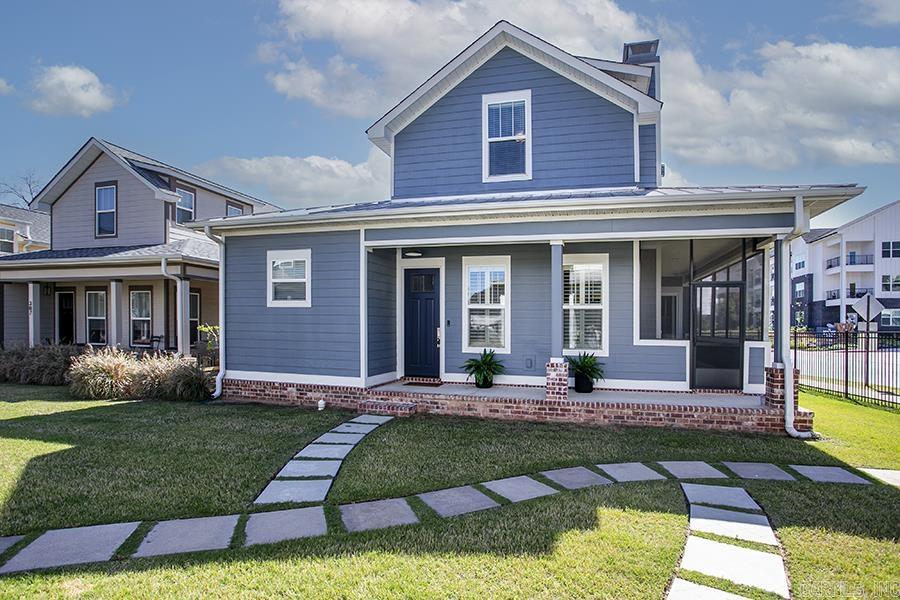 Charming and fresh, this Porches of Rockwater home is located just steps from the Arkansas River Trail and minutes to Argenta and downtown Little Rock/NLR. Open-concept floor plan with 10' ceilings. Welcoming kitchen with abundant natural light and breakfast bar. Wonderful main level primary suite, Pella windows/doors, LVP flooring, gas fireplace, and quartz countertops. Main-floor also has nice bright laundry room and half bath. Upstairs landing perfect for small desk, sitting area or library with two nice size bedrooms and a full bath. Enjoy entertaining and relaxing on the screened-in side porch. Home has metal roof, rear-loading garage, and welcoming front porch. HOA covers lawn care, fire pit, and fencing.