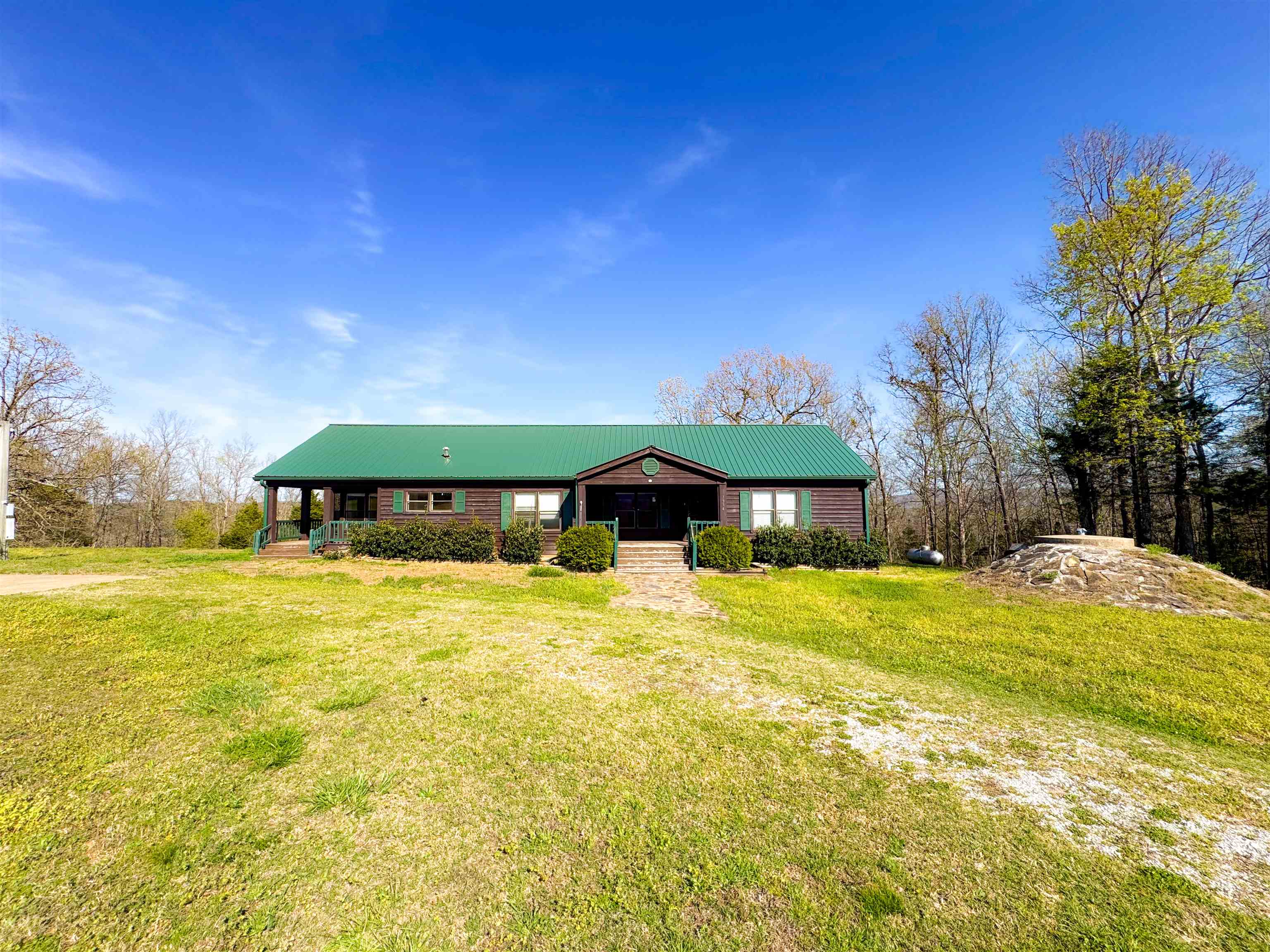This spacious 2,100 sq. ft. home set on 4+/- acres with a truly stunning mountain view. The 3-bed, 2-bath manufactured home sits on a solid block foundtaion with a thougtfully designed addition, offering both comfort and durability. Inside, you'll find inviting features such as a gas log fireplace, sunroom/formal dining area with hardwood floors, a spacious kitchen, and a custom tile walk-in shower in the oversized primary bath. A metal roof and an above-ground storm shelter add peace of mind. Outdoors, the property shines with a 40x30 two-bay shop complete with electricity and a bathroom -- perfect for hobbies, storage, or workspace needs. All of this is located just on the outskirts of beautiful Mountain View, offering privacy, scenery, and convenience in one exceptional package.
