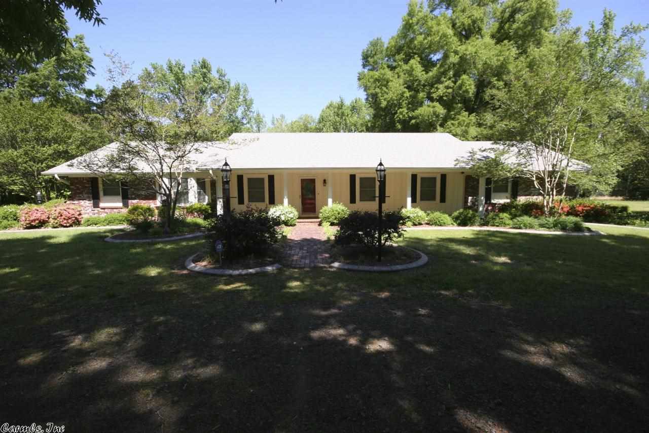 This beautiful home is set on a 15 acre piece of land that has 5 acres of beautiful clearing and approximately 10 acres of untouched timber.  The house has 4 bedrooms and 2.5 bathrooms and has been modernized in many ways.  The kitchen has Quartz counter tops complete with a chef's island with roll out shelving.  Wood Laminate Flooring and a Vaulted Ceiling in the large great room.  This home also features a indoor sun-room breezeway that connects the garage and main living areas.  See agent remarks.
