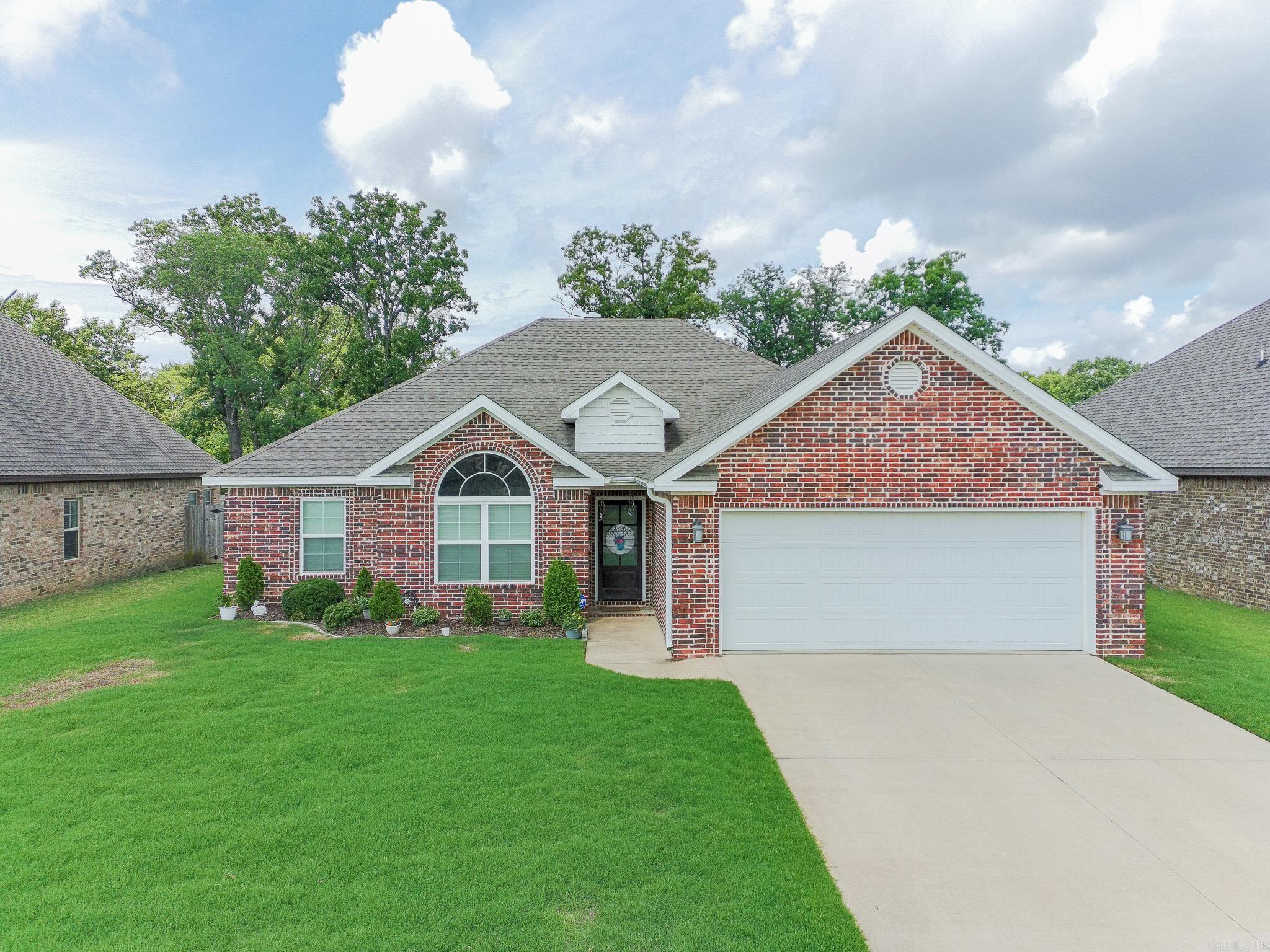 Move-in ready and beautifully designed, this 4-bedroom, 2-bath all-brick home in the highly sought-after Valley View School District offers the perfect blend of comfort, style, and efficiency. Step inside to an open-concept floor plan featuring impressive 12-foot raised ceilings in the great room, kitchen, and breakfast area, creating a spacious and inviting atmosphere. Multiple windows surround the breakfast area, filling the home with abundant natural light. The kitchen is both functional and stylish with granite countertops, a stainless farmhouse sink, subway tile backsplash, gas range, and ample workspace for cooking and entertaining. The spacious living room centers around a beautiful brick fireplace with gas logs, making it the perfect gathering space. The primary suite features a tray ceiling and a luxurious bath complete with double vanities, a relaxing soaker tub with tile surround, custom tile walk-in shower with glass door, and an oversized walk-in closet. Designed with a desirable split-bedroom layout, the private primary suite is separated from the additional bedrooms for added comfort and functionality.