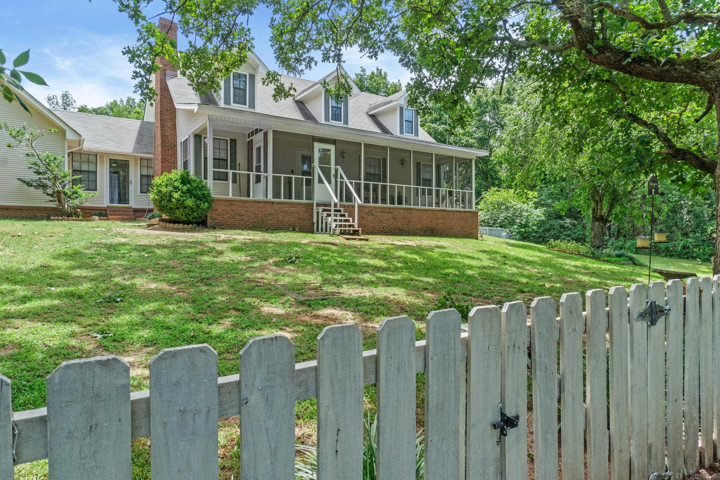 This Beautiful Home sits on a sloped hill and welcomes you as you drive up the driveway. You can sit on the screened in Front Porch and Have your morning coffee. Front yard area in front of porch is fenced in for your children and pets. Summer is here so Take a Dip in the inground pool and sit in the shade in your covered bar area. Sellers have had the crawl space encapsulated. Home is immaculate and features hard wood flooring and is ready for its new family. Master Bedroom is downstairs and flows into the ensuite master bath with large jacuzzi tub and walk in shower and double sink vanity and on into laundry room. Large Living Room for your family and the kitchen has an abundance of cabinets and bar area to eat at and plenty of room for a dining table. Nice size laundry room. Large foyer as you enter the back door which could also be a office/ craft room. 2 bedrooms upstairs and a nice size bathroom. Storm cellar on property and ad nice size shop with electricity.  RV Hook up in yard by the shop and  RV Sewer. See Agent Remarks