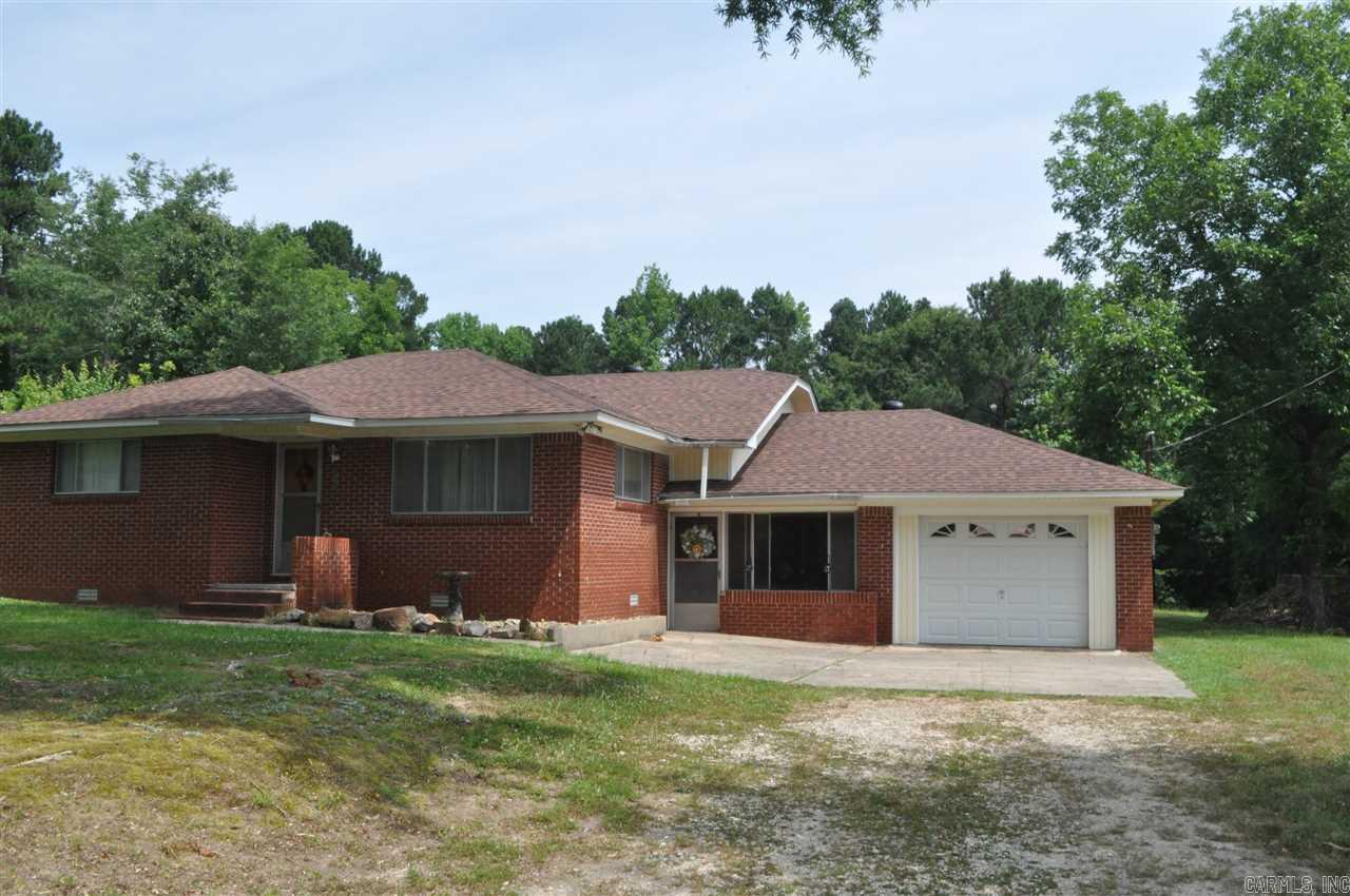 This is a very unique homeplace with character ON 9.35 ACRES.  ****ALL BRICK, NEW ROOF ON HOME, NEW METAL ROOF ON SHOP AND POLE BARN, NEW HVAC PACKAGE****LARGE BEDROOMS, EAT IN KITCHEN, AND DID I MENTION 9.35 ACRES!!! 24X28 drive thru shop with electricity and 12X28 lean-to on BOTH sides. Also a large pole barn. Also outside you will find a storm shelter made from an old phone company juntion box with NO Stairs!!! One car garage and an enclosed breezeway with laundry room and full bath, and a sitting area.
