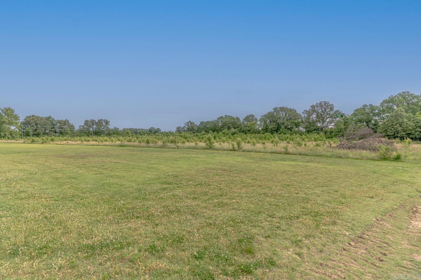 Welcome to Market 5 +/- acres off of Harrisburg Rd in Jonesboro. Situated within Jonesboro city limits and zoned R-1 is an opportunity to secure a tract of land conveniently located near Interstate 555 and U.S. Route 49. The property features level terrain, mature trees along portions of the perimeter for natural screening, and a tucked away setting offering flexibility for future investment potential. Subject to new survey and easement. Call today for additional information and to explore the possibilities this acreage holds.