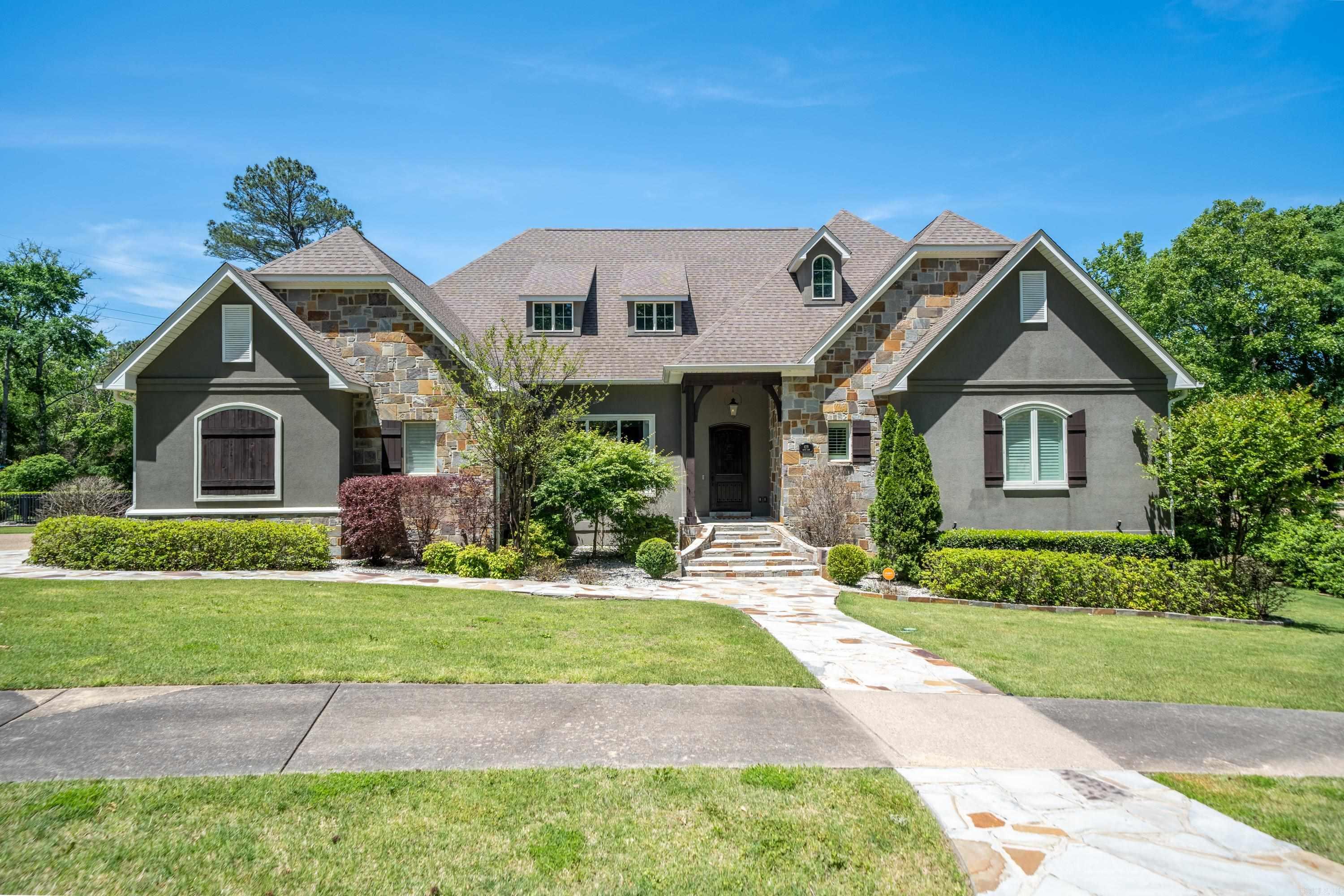 Must see this beautiful custom home that has been completely refreshed throughout and located in the coveted Lotus Valley subdivision. Features are endless with this 5 Bedroom, 4 FullBath + 2 Half Bath home, boasting over 5,600 square feet. The home sits on two lots with multiple covered patios and plenty of green space to enjoy, making it a perfect home for outdoor entertaining. The interior includes, a high end kitchen, with an oversized island and SS appliances, large vaulted living space, hardwood floors throughout, and much more.