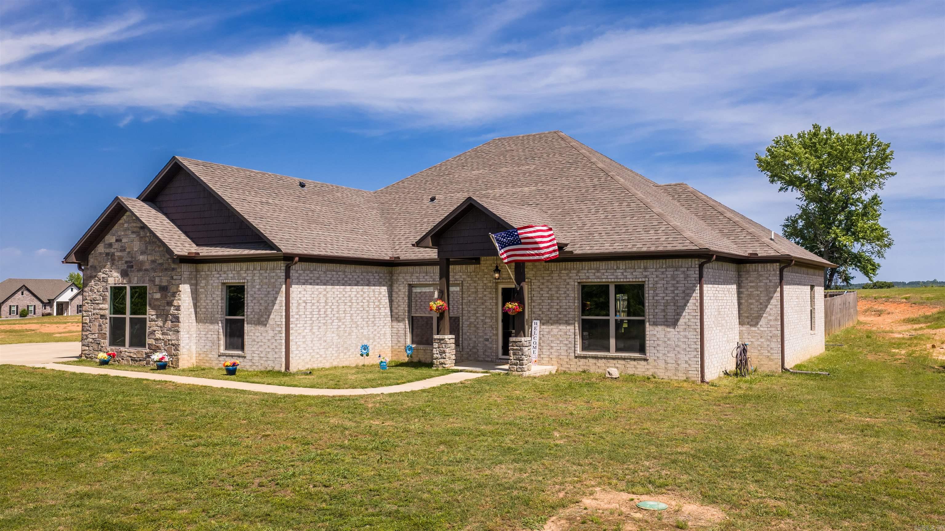 Seller is offering $5,000 seller credit & 1 Year Home Warranty. Plus the washer, dryer, & refrigerator stay with the home. Welcome home to this stunning 2022-built property sitting on 2 beautiful acres in Greenbrier! This 4 bedroom, 2.5 bathroom home offers a spacious layout with luxury vinyl flooring, a cozy gas fireplace, and a thoughtfully designed kitchen featuring double ovens, a pantry, and plenty of space for entertaining. The primary suite includes a soaking tub and dual closets for added comfort and convenience. Outside, you’ll love the fenced yard, covered patio with extended concrete pad, gutters, and oversized driveway space. Complete with a 3-car garage and modern finishes throughout, this home blends comfort, style, and functionality in one incredible package. With plenty of room to build a shop!