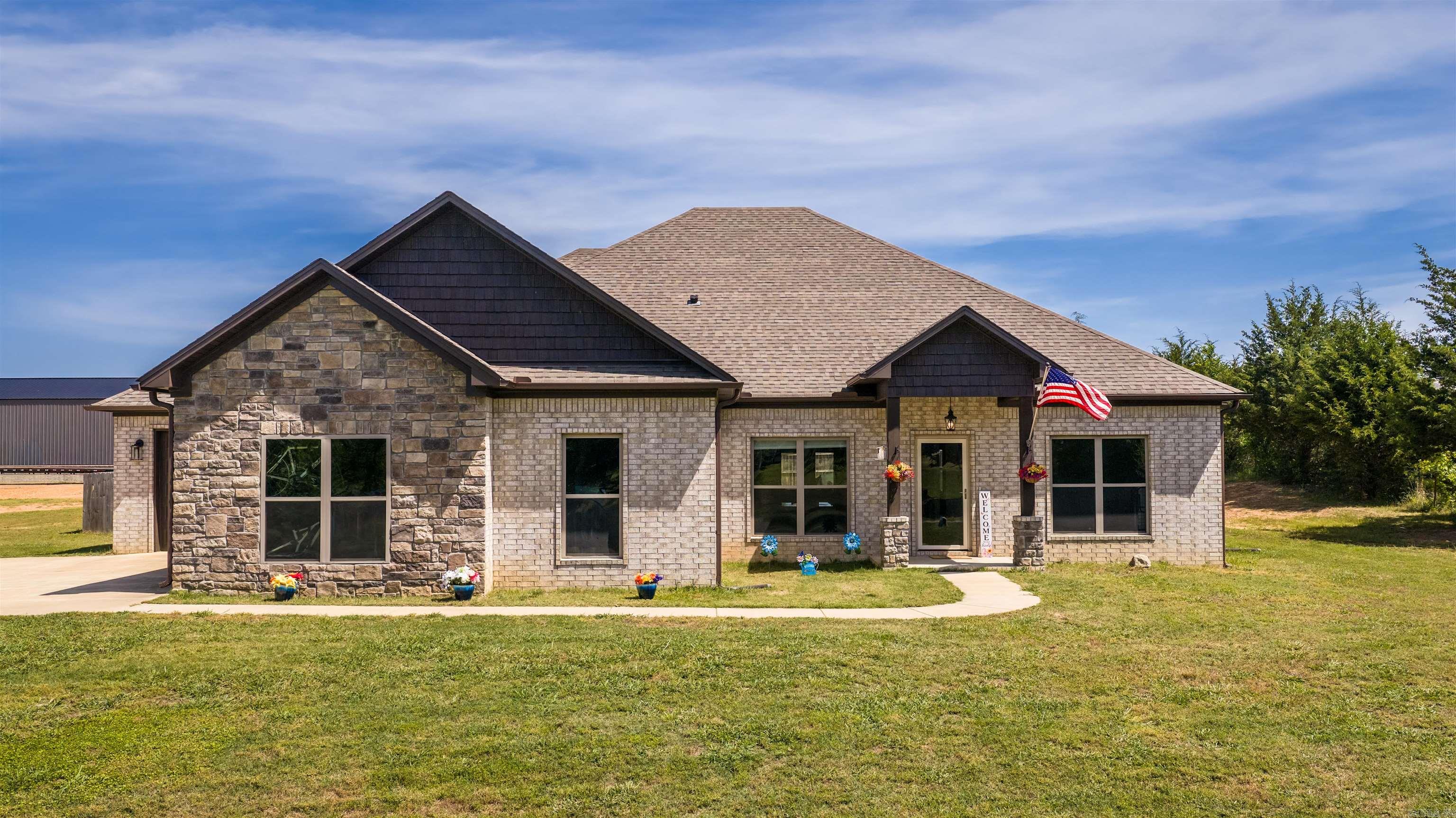 Seller is offering $5,000 seller credit & 1 Year Home Warranty. Plus the washer, dryer, & refrigerator stay with the home. Welcome home to this stunning 2022-built property sitting on 2 beautiful acres in Greenbrier! This 4 bedroom, 2.5 bathroom home offers a spacious layout with luxury vinyl flooring, a cozy gas fireplace, and a thoughtfully designed kitchen featuring double ovens, a pantry, and plenty of space for entertaining. The primary suite includes a soaking tub and dual closets for added comfort and convenience. Outside, you’ll love the fenced yard, covered patio with extended concrete pad, gutters, and oversized driveway space. Complete with a 3-car garage and modern finishes throughout, this home blends comfort, style, and functionality in one incredible package. With plenty of room to build a shop!