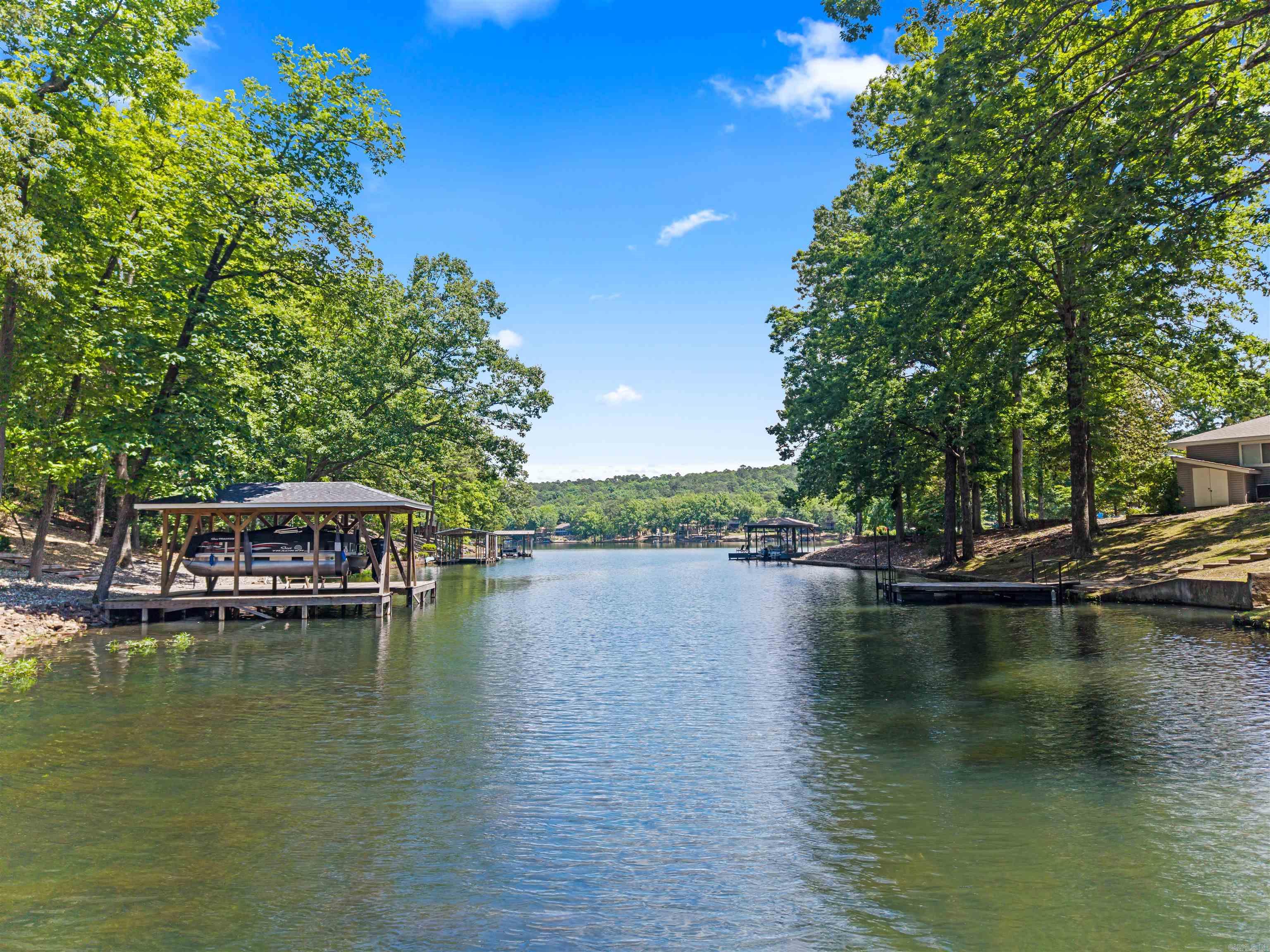 BEAUTIFUL LAKE DESOTO LIVING!  Relax your cares away in this newly-remodeled two-story 4 bed 2bath home! Lakefront living shines with upper & lower decks showcasing gorgeous views & a private covered dock with separate swim/fishing deck offering exclusive lake access & the perfect launching point for exploring Lake Desoto! Sunbathe or fish off your own dock, or take a short boat ride to the nearby beach & delicious lakeside dining at Waypoint Marina! From inside, you will enjoy breathtaking views straight out to the water in the spacious open-living areas! Kitchen features like leathered granite countertops, soft close cabinetry, a serving area with coffee bar, stainless appliances, luxury vinyl plank floors, & a huge walk-in pantry make culinary entertaining a delight!  The split floor-plan affords privacy in 3 spacious guest bedrooms & a lavish primary ensuite complete with double vanities, a luxury walk-in shower, & its own private deck! Abundant inside storage, a large home office, an over-sized 2- car garage, a full laundry/supply room, & loads of outdoor storage for all your lake toys in the 9ft ceiling workshop provide perfect functionality.  See attached list of updates!
