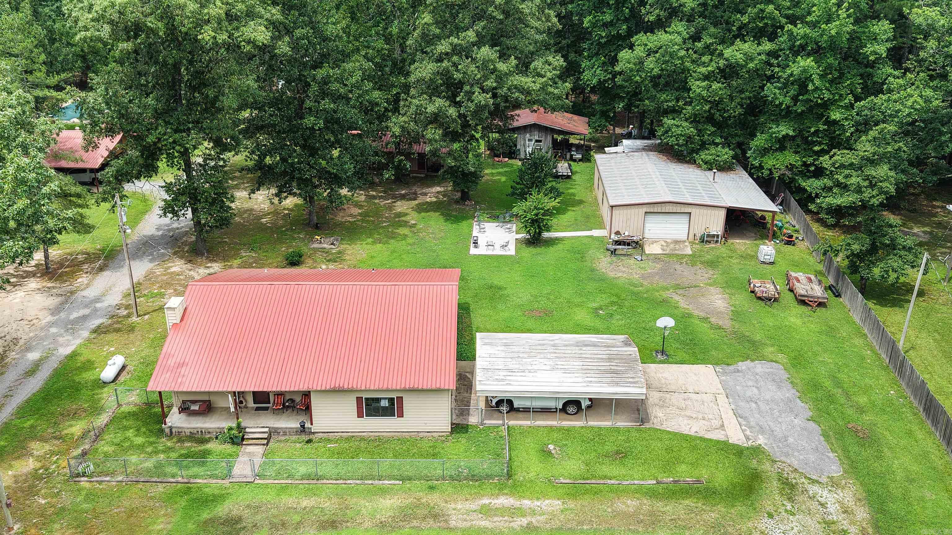 Country living just outside the city. This incredible property has so many opportunities just waiting for a buyer. There are two shops and two storage buildings located on the property perfect for storage, hobbies, or family gatherings. The main shop is 30'x50' with a bathroom and air-conditioned room built inside the shop, and the second shop is 12'x36' with a 6'x36' porch on the front. Enjoy the seclusion of being outside of the city while only being minutes from town. This house is Rural Development eligible which means as low as 0% down for qualifying buyers. Call today to schedule your showing.