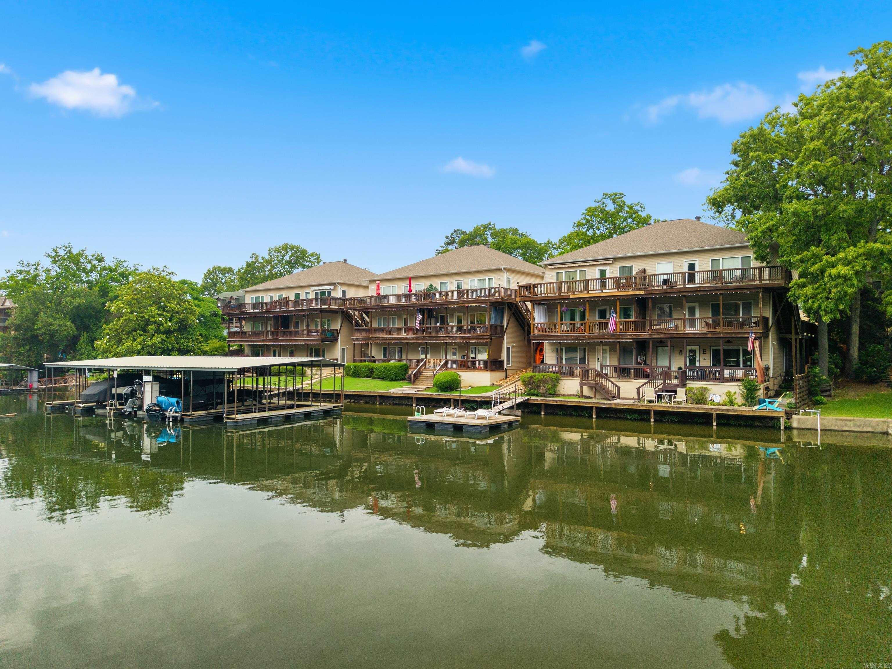 Welcome to Lake Hamilton in Hot Springs, just in time for summer!  A walk-in level 2 bedroom, 2 bath lake condo sitting right on waters' edge; selling fully furnished and stocked.  Step outside on the covered balcony to relax and enjoy the lake views and activities. A great quiet cove to appreciate kayaking, floating, fishing, and spending time on the swim dock. Launch your boat 1/4 mile down the road at the marina, and tie-up on the boardwalk - a great location just one mile from Central Avenue, restaurants, local shops, and Oaklawn. Schedule your showing and enjoy meeting your full-time residents/no nightly rentals allowed.