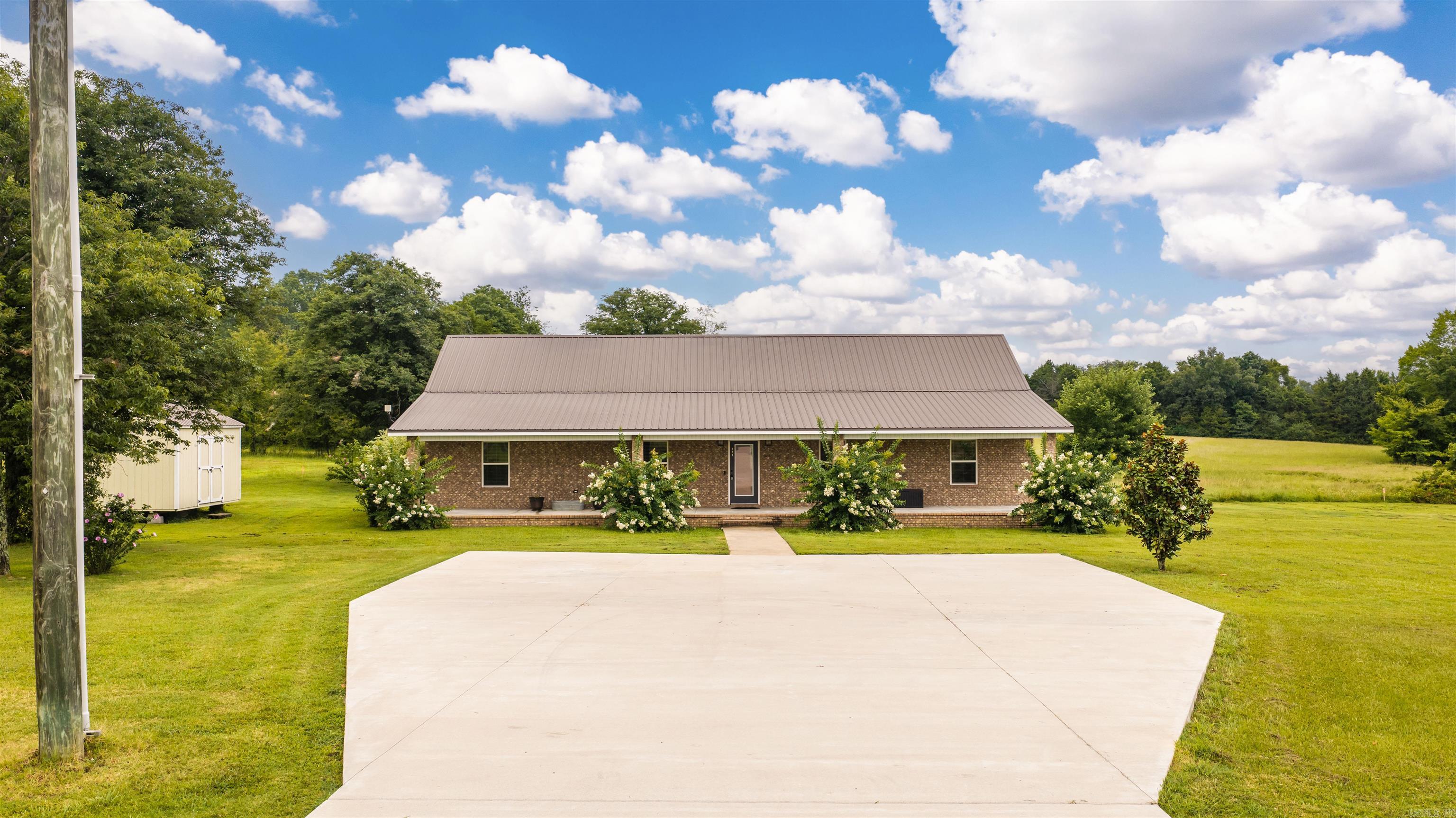 Spacious home on just over an acre. The home sits on a level lot with no restrictions. Two nice storage buildings will stay. Whole house generator operates on a buried propane tank ready to go if the power ever fails. Concrete floors throughout. the primary bedroom is large and is separate from the guest bedrooms. Very large concrete parking pad. There is room to build a shop on the property. A tiny home is also included with the property. Someone is currently occupying the tiny home. Tiny home is fully functional with a private bathroom. Has a living, sleeping and kitchen space. Also has space for a washer and dryer.