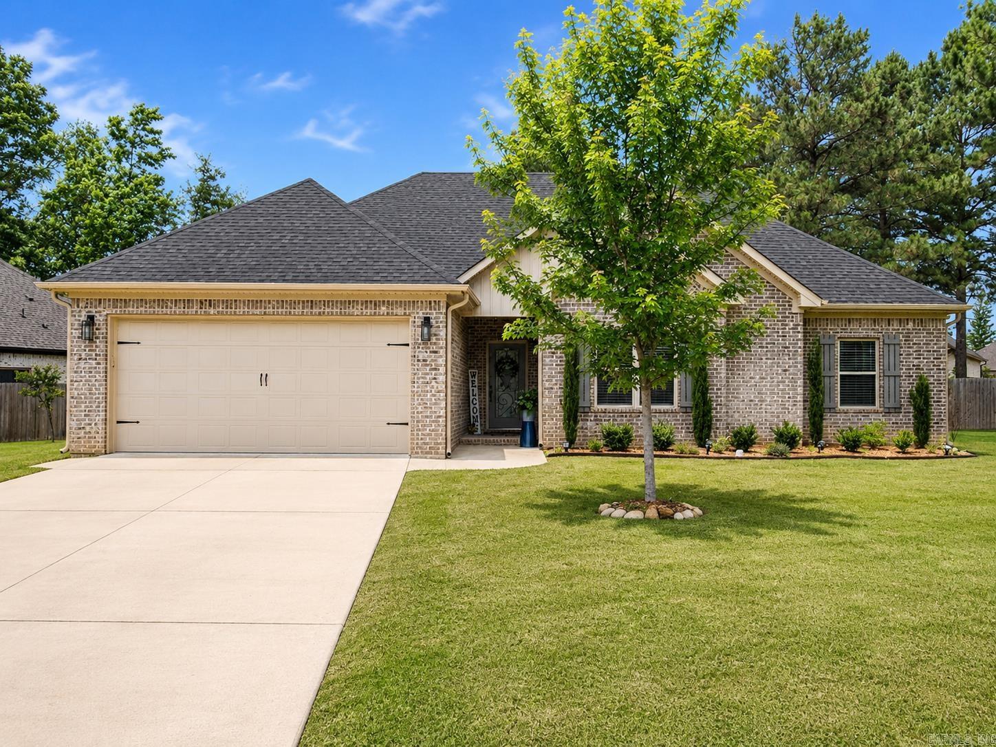 This fantastic 3-bedroom, 2-bath home situated on an oversized lot provides a spacious open floor plan designed for both comfort and functionality. The inviting living room features vaulted ceilings, creating a bright and airy feel throughout the main living space. The kitchen is a standout with a beautiful island, quartz countertops, stainless steel appliances, abundant cabinetry, a pantry and tons of storage space—perfect for entertaining and everyday living. The spacious primary suite offers plenty of room to relax and includes a custom tile shower along with generous closet space. Two more generous bedrooms and full bath round out this home. Step outside to enjoy the covered patio overlooking a beautifully landscaped yard featuring maple trees and crepe myrtles, creating a peaceful outdoor setting. Conveniently located with easy access to the highway, shopping, and dining, this home offers the perfect combination of beauty, space, and convenience.