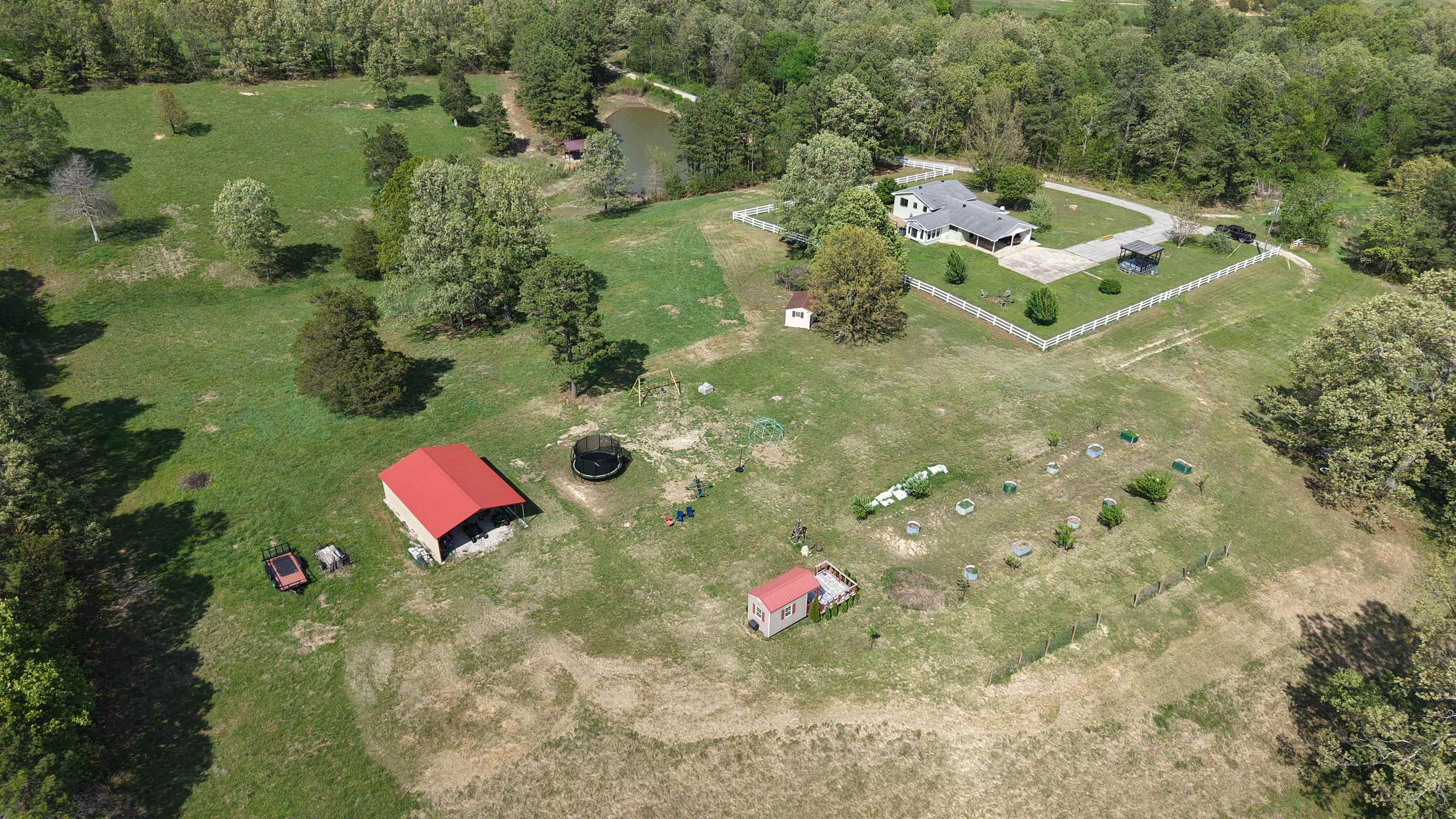 This custom 3-bedroom, 1 ½ -bathroom home offers 2,008 sq ft of living space and resides on 15.29 acres in the Ozarks of Oxford, Arkansas. This property features intentional landscaping and manicured grounds that truly set it apart. The land includes open pastures, suitable for livestock or small-scale farming, along with mature oak and pine trees. A stocked 1-acre pond with a fishing dock is also located on the property.  For those with a passion for sustainable living, the property offers a spacious garden area and a small orchard, ready to support your homesteading dreams. A fenced yard, large deck and patio, craft shed and multiple outbuildings provide both functionality and appeal. Other improvements include new playground equipment, and a 1,000-gallon propane tank that fuels the Generac 20 KW Generator, all of which convey. Additional equipment shown in listing photos is available for purchase. Whether you're looking to start a hobby farm, enjoy country living, or create your own homestead, this one-of-a-kind property delivers space, versatility, and timeless Ozarks appeal, all for $474,900.