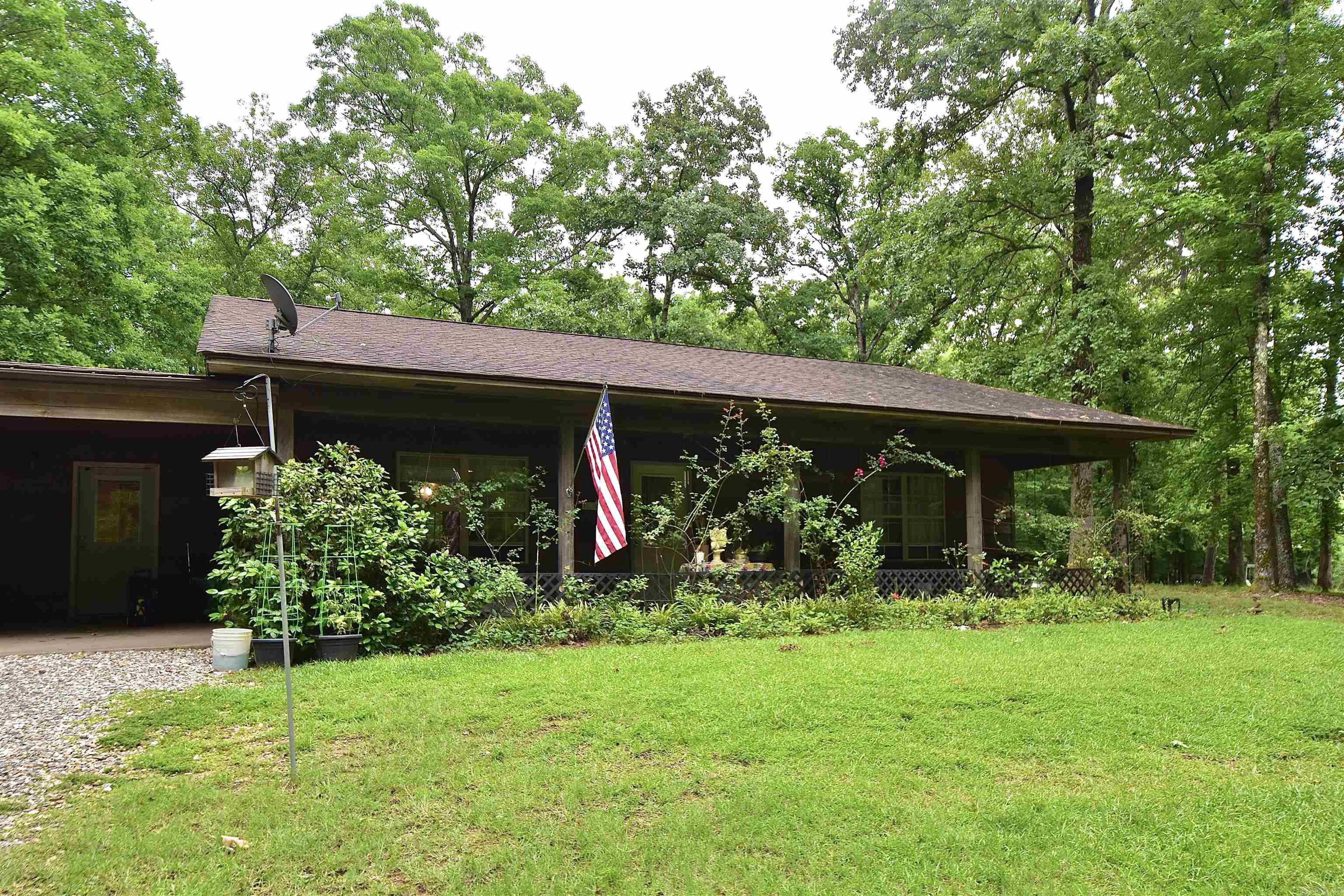 Welcome to 2736 Riverview Dr in the prestigious Riverview gated subdivision of Malvern, Arkansas! Nestled on 3.54 mostly wooded acres just minutes from the Ouachita River, this unique 3-bedroom, 3-bath home offers the perfect blend of privacy, space, and convenience. Located only 3 minutes from Ouachita River Whitewater Park and 6 minutes from Walmart, you can enjoy peaceful country living while staying close to town amenities. Inside, you’ll find open living and kitchen area featuring beautiful oak cabinets and plenty of space for gathering and entertaining. The spacious primary includes a walk-in master closet, providing ample storage. An attached mother-in-law quarters offers its own bedroom, bathroom, and living area, perfect for guests and family. Enjoy the surrounding nature from the inviting front and back porches overlooking the property. Outside, you’ll find a woodshed complete with electricity and AC, ideal for a workshop, hobby space, or extra storage. The property also features a two-car attached carport plus an additional detached carport around back for extra parking and storage. Property being sold as is. Do not miss your opportunity to call 2736 Riverview Dr home!