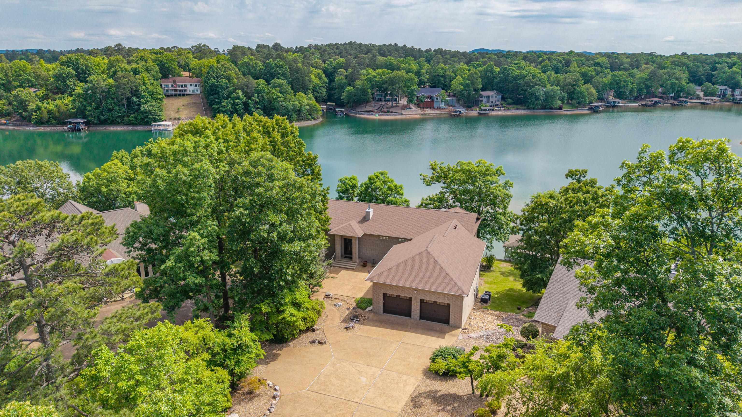 Welcome to lake living at its best in beautiful Hot Springs Village Gate Community! This home offers the perfect blend of comfort, relaxation, and recreation with peaceful waterfront views and your own private dock for fishing, boating, or simply enjoying the outdoors on Lake Balboa. Whether you’re looking for a full-time residence, vacation getaway, this lake home delivers the ideal Arkansas lifestyle. Inside, you’ll find a warm and welcoming atmosphere with spacious living areas, abundant natural light, and great spaces for entertaining family and friends. Step outside and enjoy the serene setting from the large deck and lower pation or head down to the dock for a day on the water. Ownership in Hot Springs Village includes access to outstanding amenities such as multiple championship golf courses, lakes, marinas, swimming pools, tennis and pickleball courts, walking trails, fitness centers, restaurants, and gated security. Conveniently located near Hot Springs shopping, dining, and entertainment, this property offers the perfect combination of peaceful lakefront living and resort-style amenities. HSV has a $2000 buy in fee for new owners.