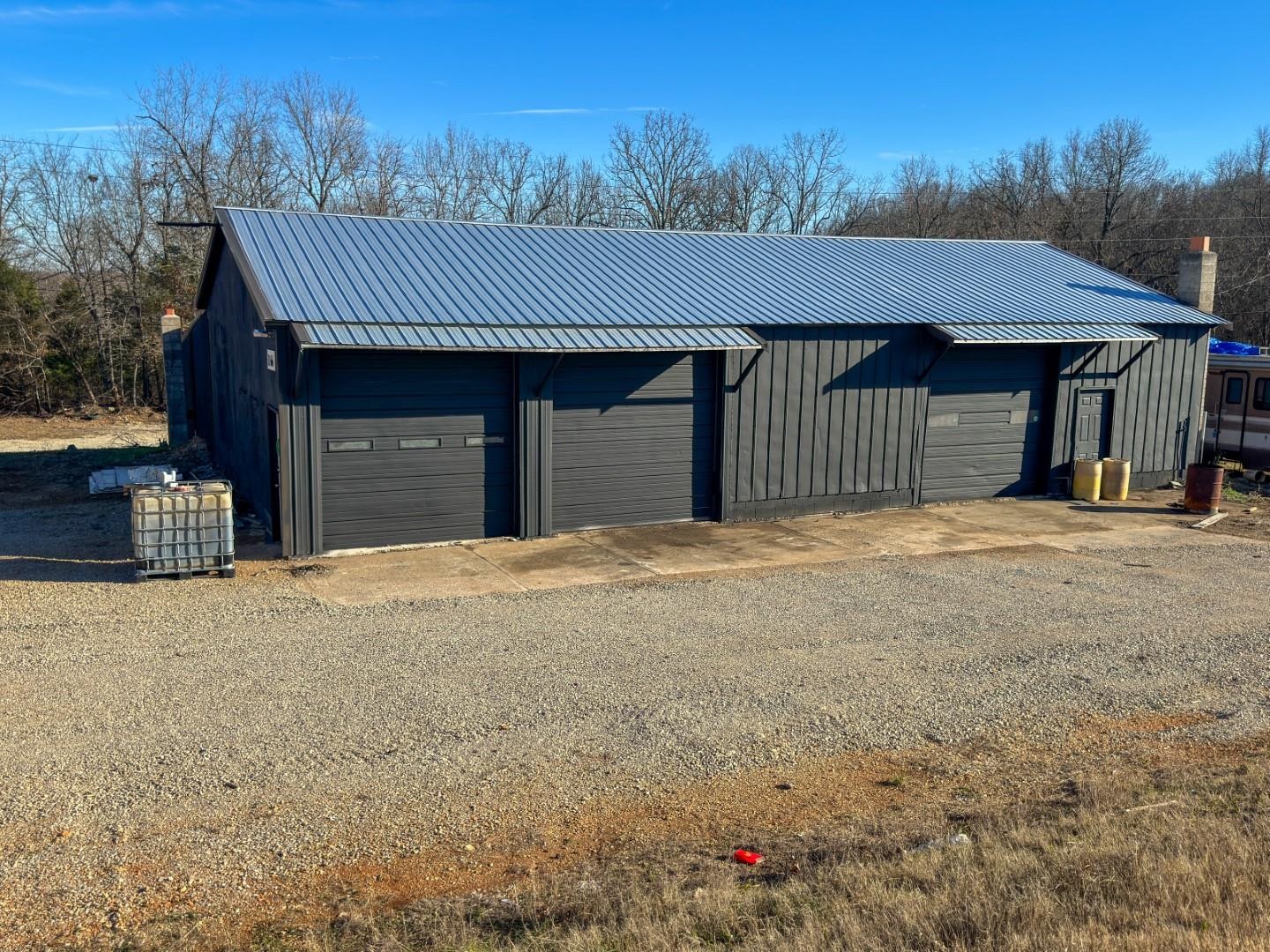 Prime Commercial Service Facility – Highland, AR... Rare opportunity to own a high-visibility, 4,320 sq. ft. service facility strategically located on the high-traffic corridor between Jonesboro and Mountain Home. This durable all-metal building is rugged and ready for automotive professionals, hobbyists, or serious collectors. The shop floor features oversized garage bays equipped with hydraulic car lifts and integrated retractable air hose reels, significantly reducing startup or relocation costs. The layout includes multiple interior flex rooms—ideal for office space, a customer lobby, parts storage, or whatever you need. With a vision and a little TLC, this property could offer the perfect footprint for a trade headquarters, maintenance hub, dream hobby shop, or a "toy box" for your private collection. Call today!