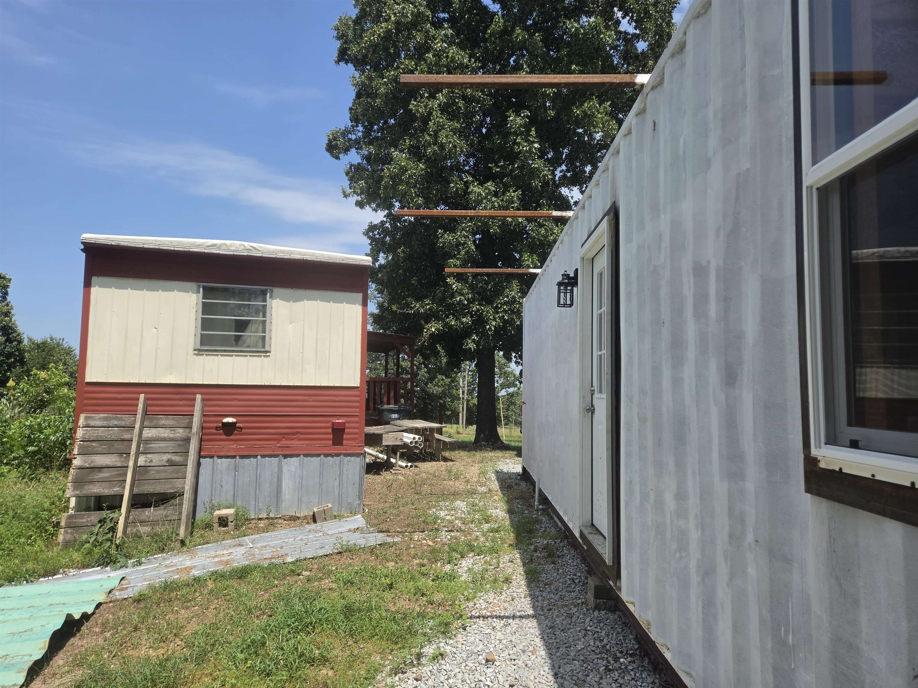 Come and finish this container home: 2-40X8 insulated, plumbed and electrical ran. List price includes ceiling fans, 2-sliding glass doors and ductless minisplit to finish out. Has 3 windows and one standard door installed. EXCELLENT view from the front deck of the manufactured home, small but energy efficient. Newer fiberglass septic tank. Wall, 5 burner propane heater and 2 window air units. About 2 acres of land with neighbors far enough away that it feels like more. On county highway between Horseshoe Bend and Salem. NAEC electricity and NEXT fiber optic internet, Fulton County water. Being sold as is where is. Owner financing available with acceptable terms and down payment. It does sit in a subdivision with restrictions, but very minimal-livestock allowed.