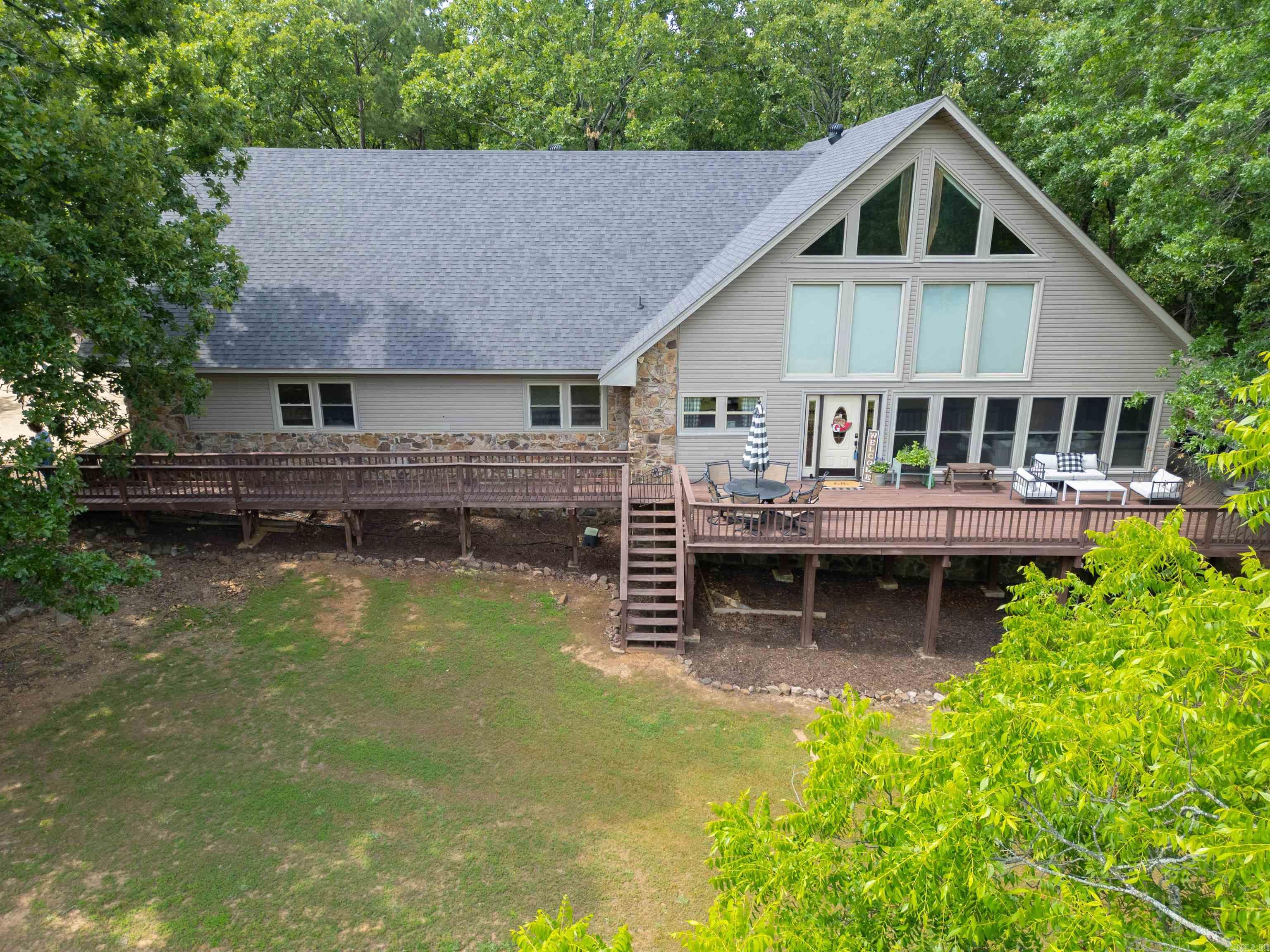 Stop and look no further.... 23+/-  acres in Cabot school district just outside of city limits. This land boasts a stocked pond, ducks, deer and turkey. Sit on your amazing wrap around deck enjoying your own little piece of sanctuary nestled right between Greystone and Magness Creek Subdivision. This one of a kind 3 car garage home includes vaulted A-frame style ceilings, wall to floor windows, a very large rock wood burning fireplace that is equipped with a blower that vents to each room, new modern tile in living and kitchen area, huge quartz dining bar in the remodeled kitchen (2022)with new stainless steel appliances, 3 bedrooms downstairs and one lofted master with a huge cedar dressing room upstairs that includes a bathroom with walk-in shower and luxurious soaker tub. Not having a space to do your laundry is no issue for this home as it proudly presents a large area with built in cabinets. If that is not enough enjoy a shop with 2 more garage doors and the Back yard has a dog run with a fenced in area for your pets. New Roof in 2022! Measuring encouraged. This unique property will not last. Developers and Builders are encouraged to view this property.