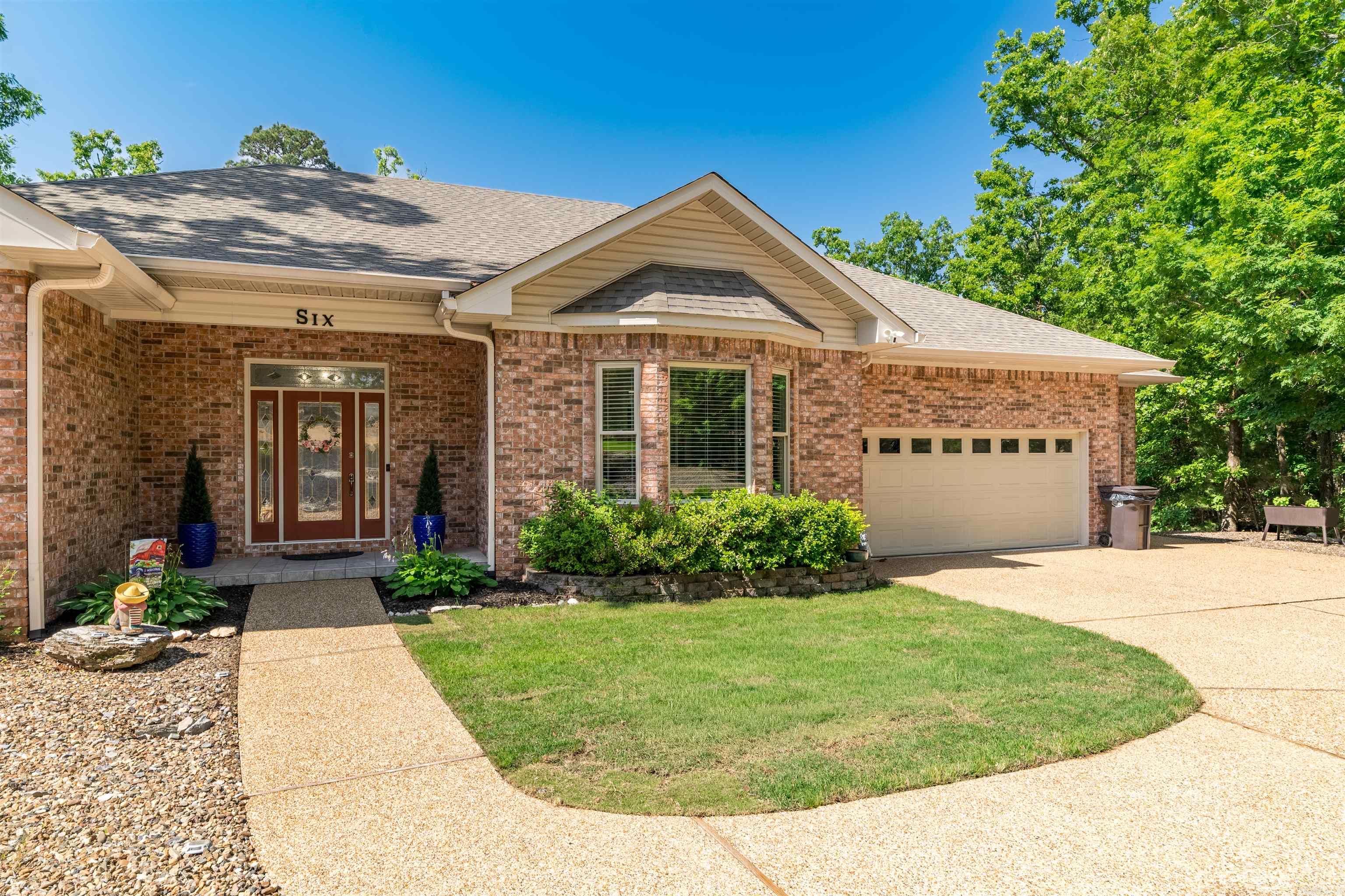 This beautifully updated golf course home offers a warm, modern feel in one of the most scenic areas of Hot Springs Village. Located just 5 minutes from Balboa Beach, the setting combines peaceful golf course views, mature trees, and the quiet atmosphere that makes Village living so desirable.  Inside, the home has been thoughtfully opened up to create a bright, flowing layout filled with natural light from the tall windows overlooking the 7th hole of Magellan Golf Course. The kitchen was completely redesigned with custom cabinetry, quartz countertops, upgraded appliances, and a large island that anchors the main living space. The primary suite offers a fully reconfigured bath with an oversized tiled shower and custom storage. The finished basement "400 sqft" adds additional living space, and a half bath, creating the perfect spot for hobbies and projects. The screened porch and updated decking create comfortable outdoor spaces to relax and take in the golf course setting year-round. This is a move-in ready home that blends quality updating with the natural beauty and lifestyle Hot Springs Village is known for. Too many updates/improvements to list MUST SEE!  List in Docs.  See AR